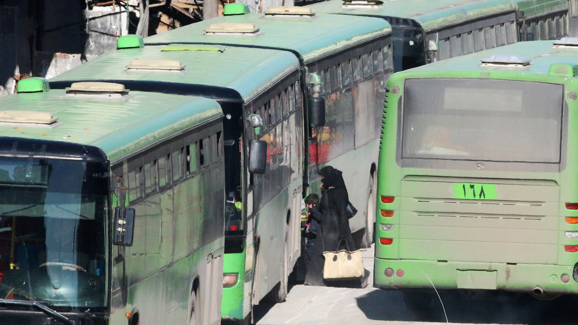 People get on buses to be evacuated from al-Sukkari rebel-held sector of eastern Aleppo, Syria December 15, 2016. 