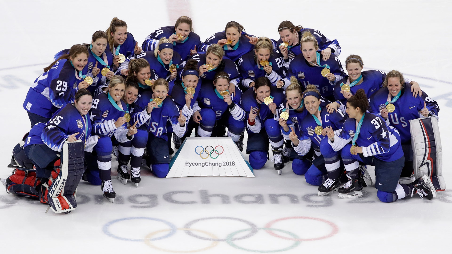 Untied States players celebrate with their gold medals after beating Canada in the women's ice hockey final at the 2018 Winter Olympics