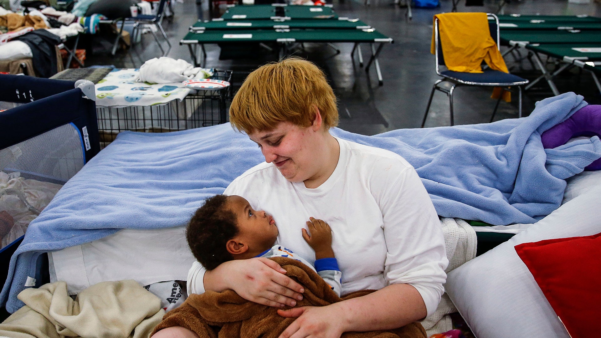 Shiann Barker holds her nephew, Brayln Matthews Sims Jr., 1, at the George R. Brown Convention Center, Wednesday, in Houston