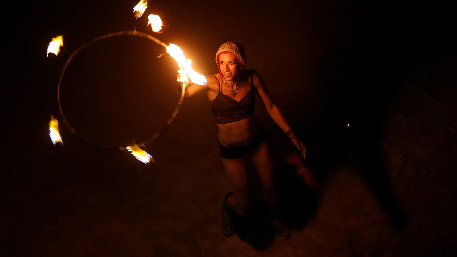A participant dances with fire before the Man burn at the annual Burning Man arts and music festival in Nevada, September 2