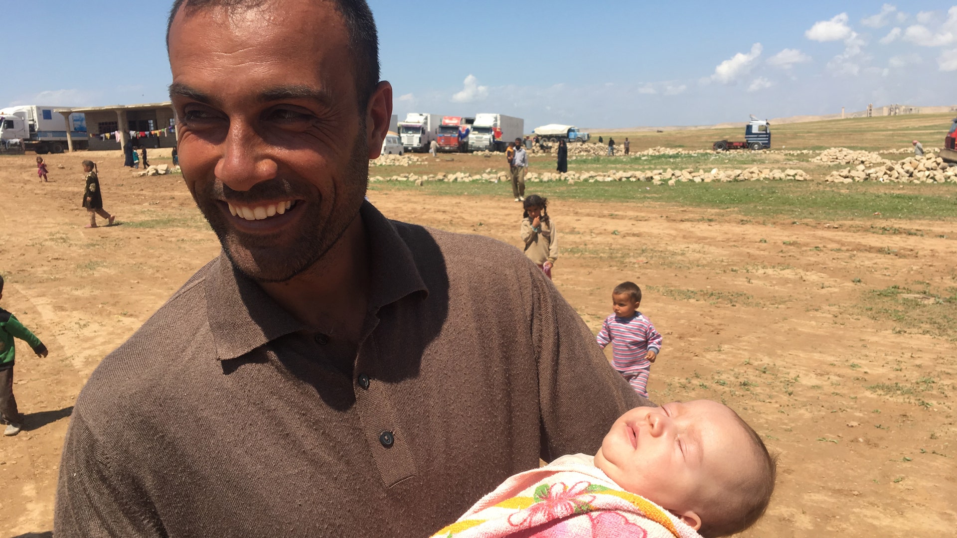 An Iraqi shepherd cares for a baby that was the product of ISIS raping and torturing the white mother, April 2017