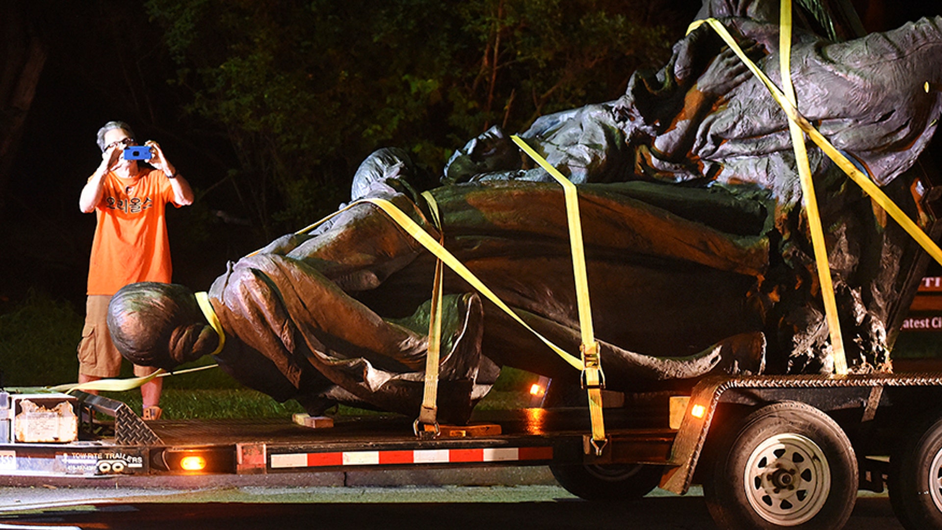 A bystander takes a picture of the monument dedicated to the Confederate Women of Maryland after it was taken down 