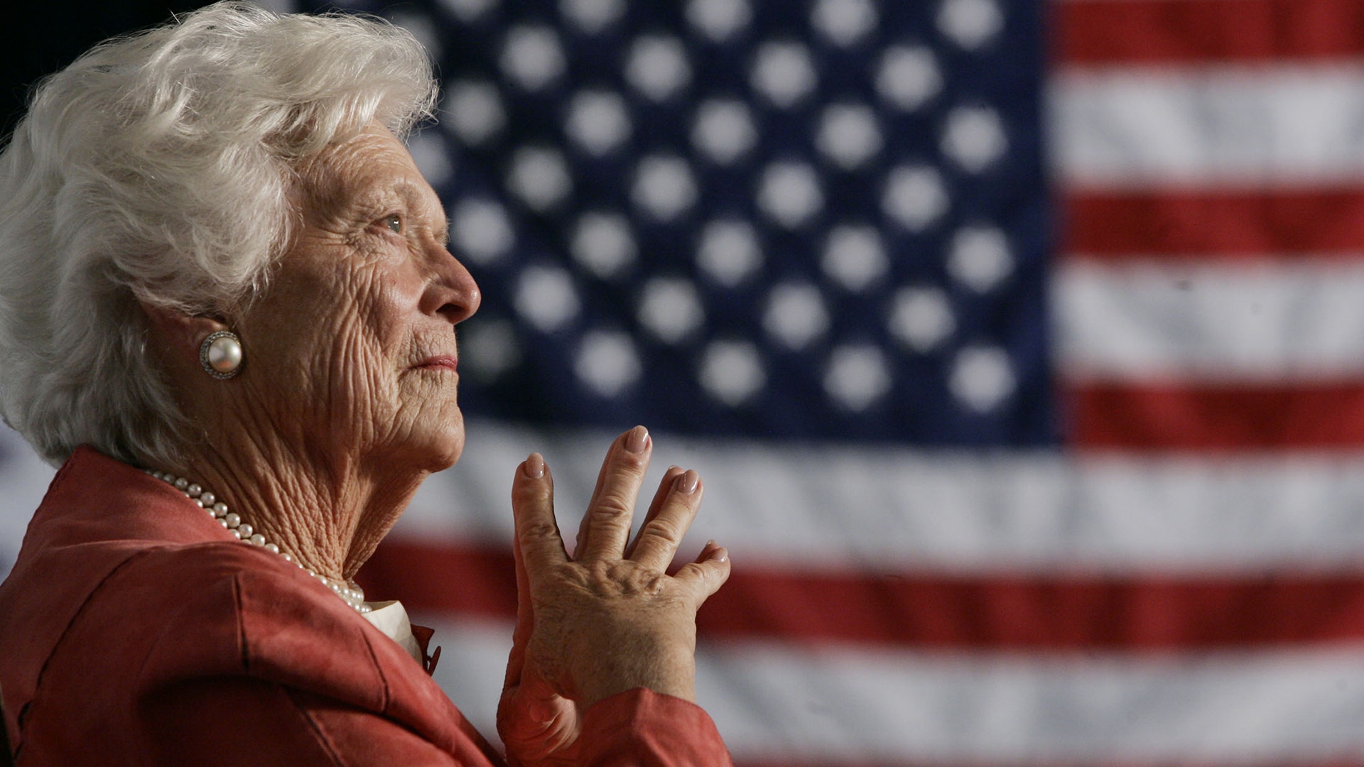 Former first lady Barbara Bush listens to her son, George W. Bush, as he speaks at an event in Orlando, Florida