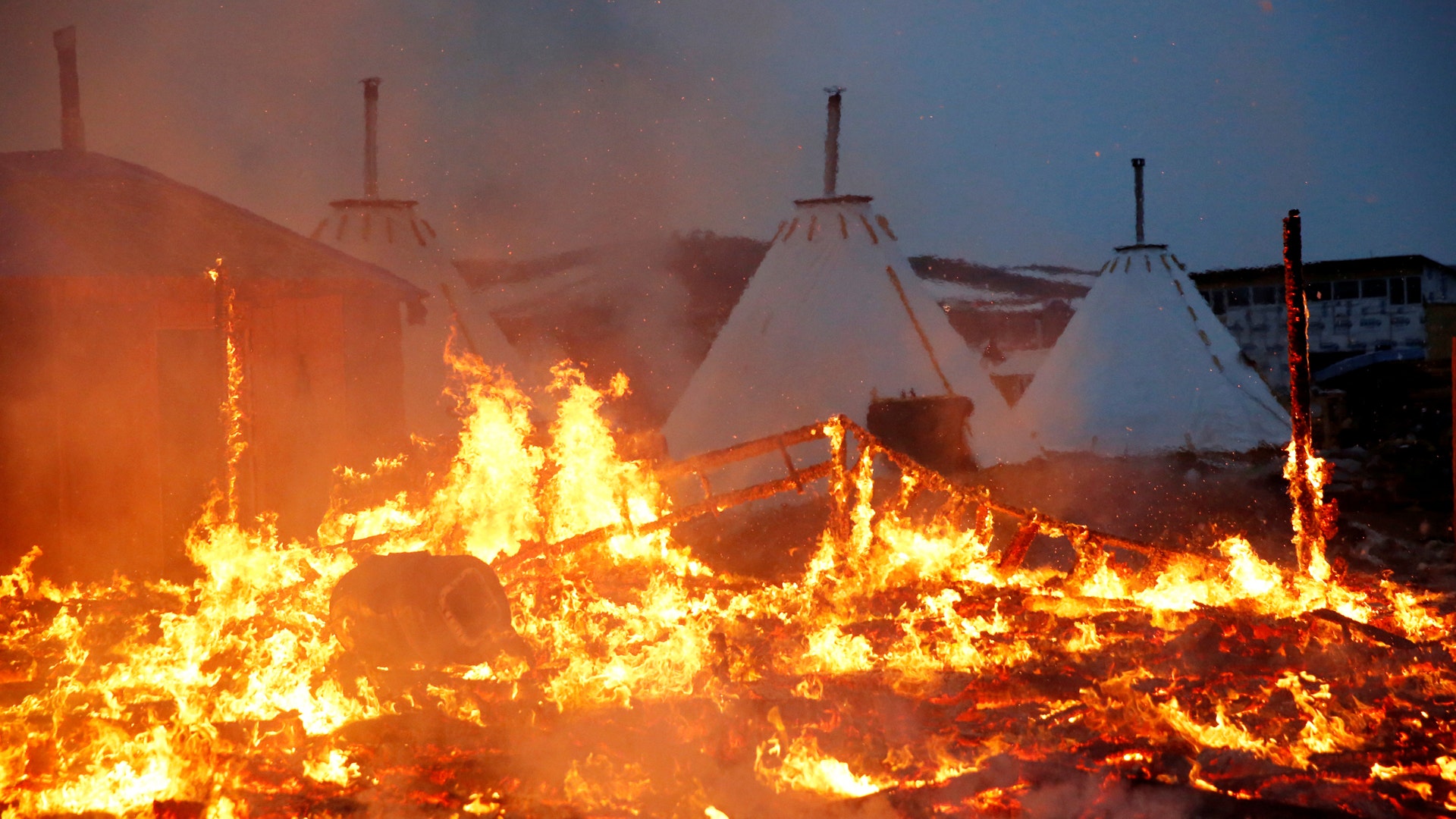 Pipeline protesters set fires ahead of camp closing near Cannon Ball, North Dakota. 