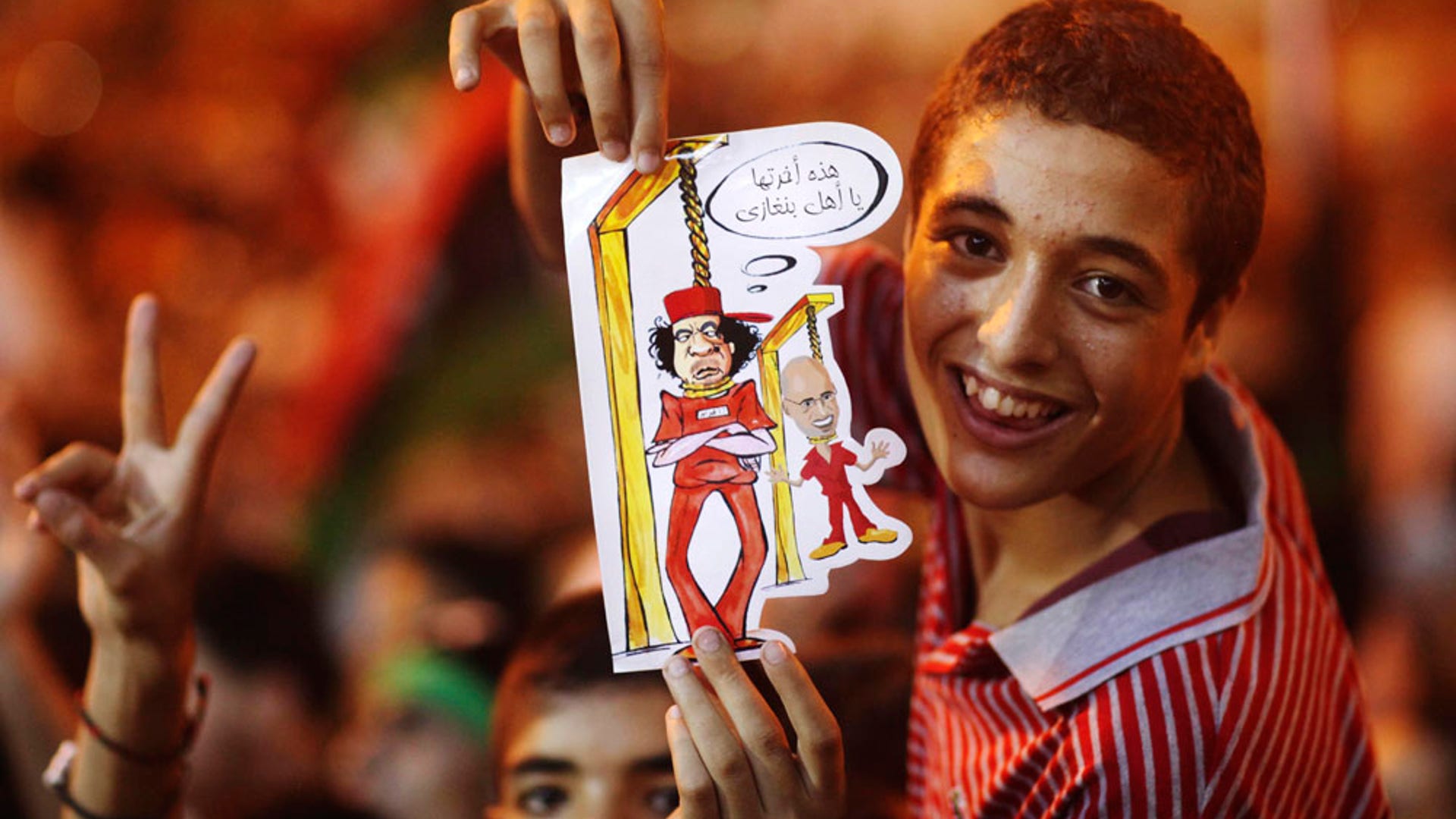 boy_holds_photo_of_qaddafi