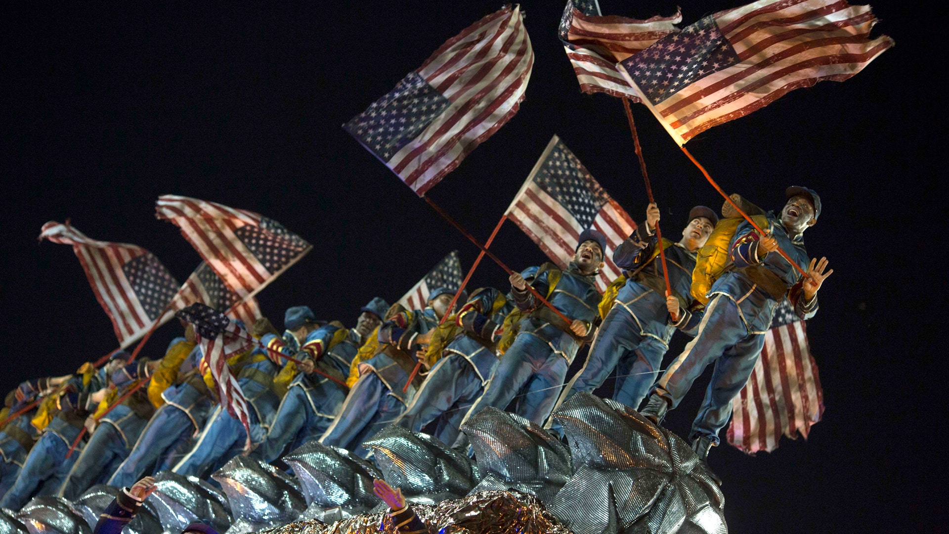 Performers from the Unidos da Tijuca samba school parade on a float during Carnival celebrations.