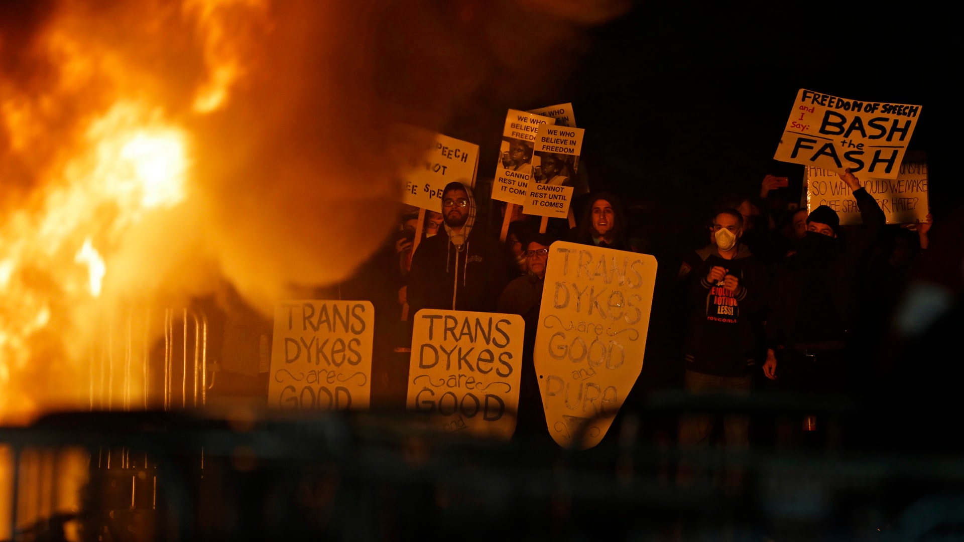 Protestors watch a fire on Sproul Plaza during a rally. 