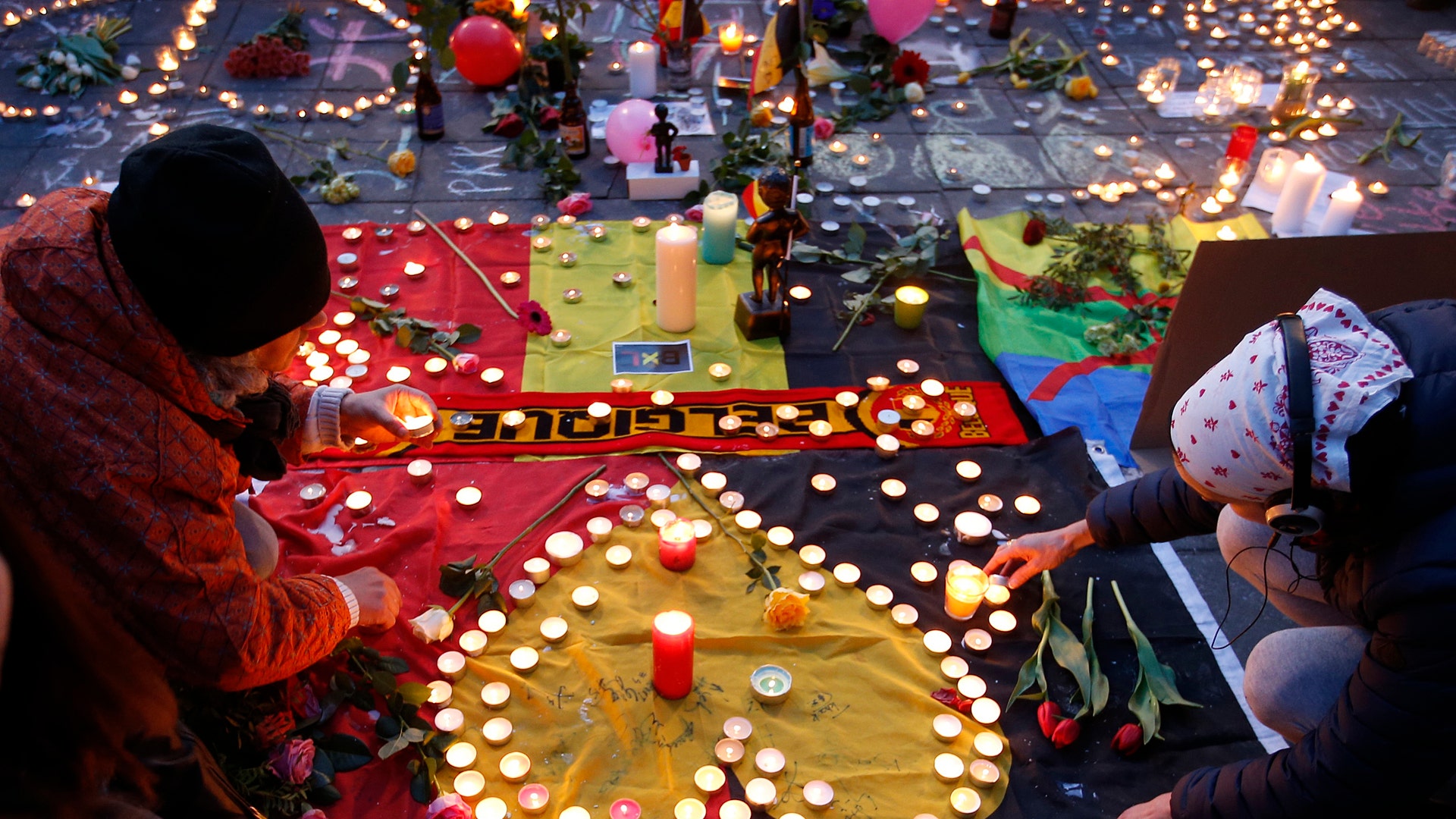 People gather around a memorial in Brussels, Belgium, March 22, 2016. 