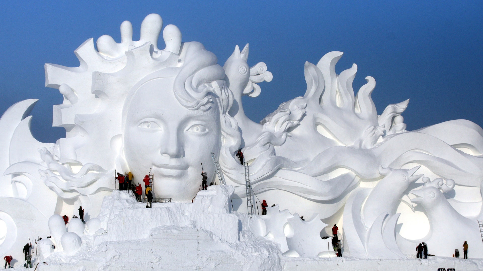 Artists work on snow sculptures at the Harbin International Ice and Snow Sculpture Festival in Harbin, Heilongjiang province, China. 
