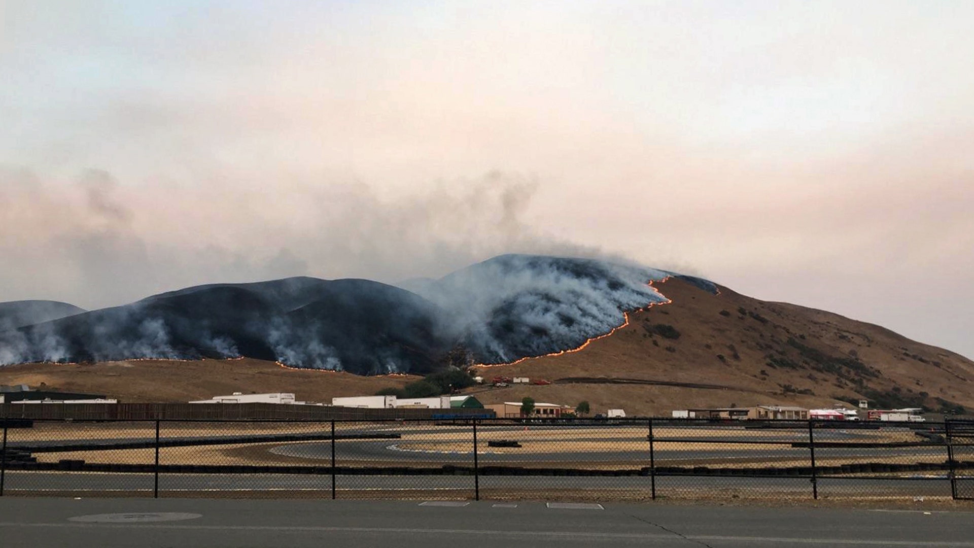 Wildfire burns behind the Sonoma Raceway, Oct. 9, 2017, in Sonoma