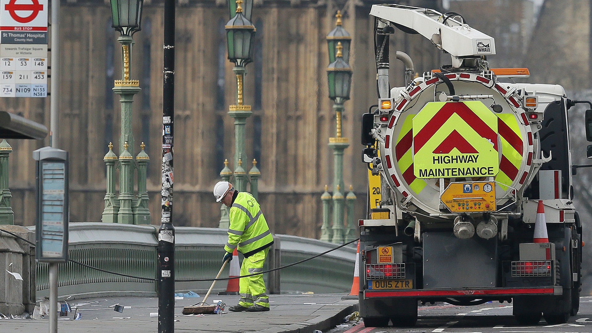 Cleaners sweep up on Westminster Bridge in London, March 23, 2017.