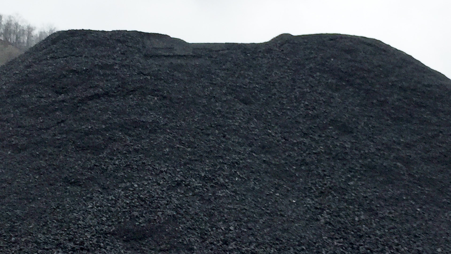 While the industry is hurting, the coal is still being produced -- tons of it, like this pile in Marmet, W.Va.