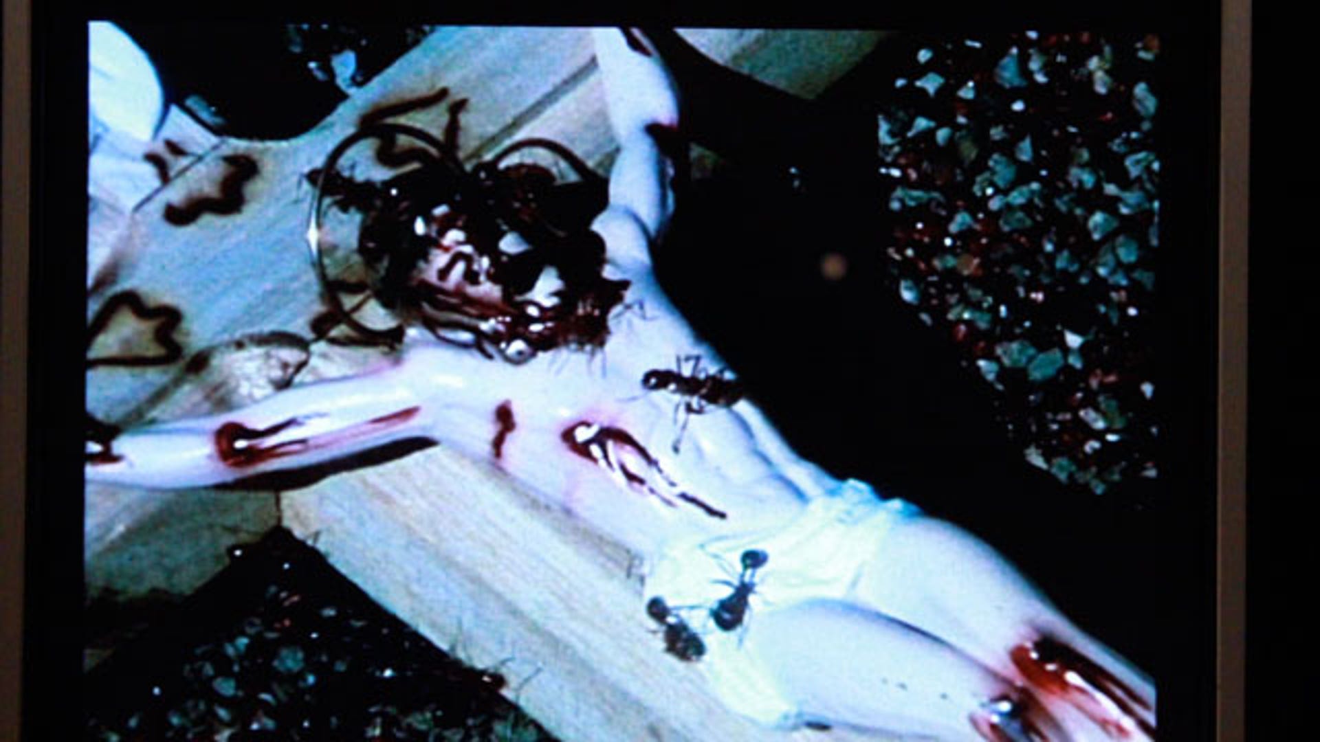 Jesus on a crucifix covered in ants