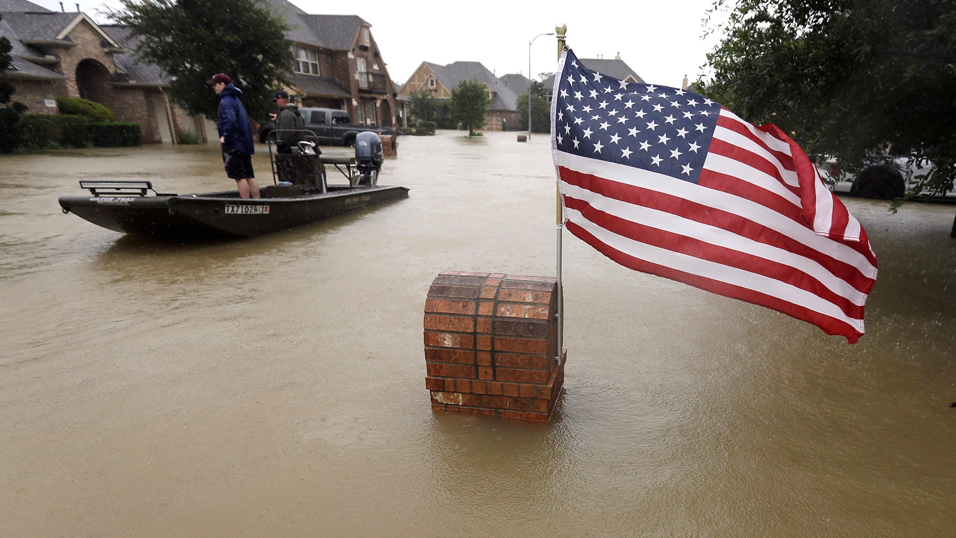 Volunteers use their boat to help evacuate residents as floodwaters from Tropical Storm Harvey rise in Spring, Texas, MOnday