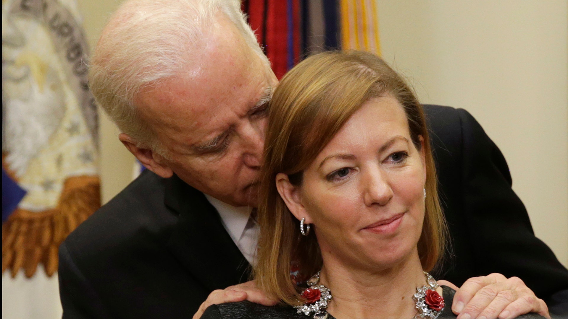 Vice President Joe Biden talks to Stephanie Carter as her husband Ash Carter speaks in Washington February 17, 2015