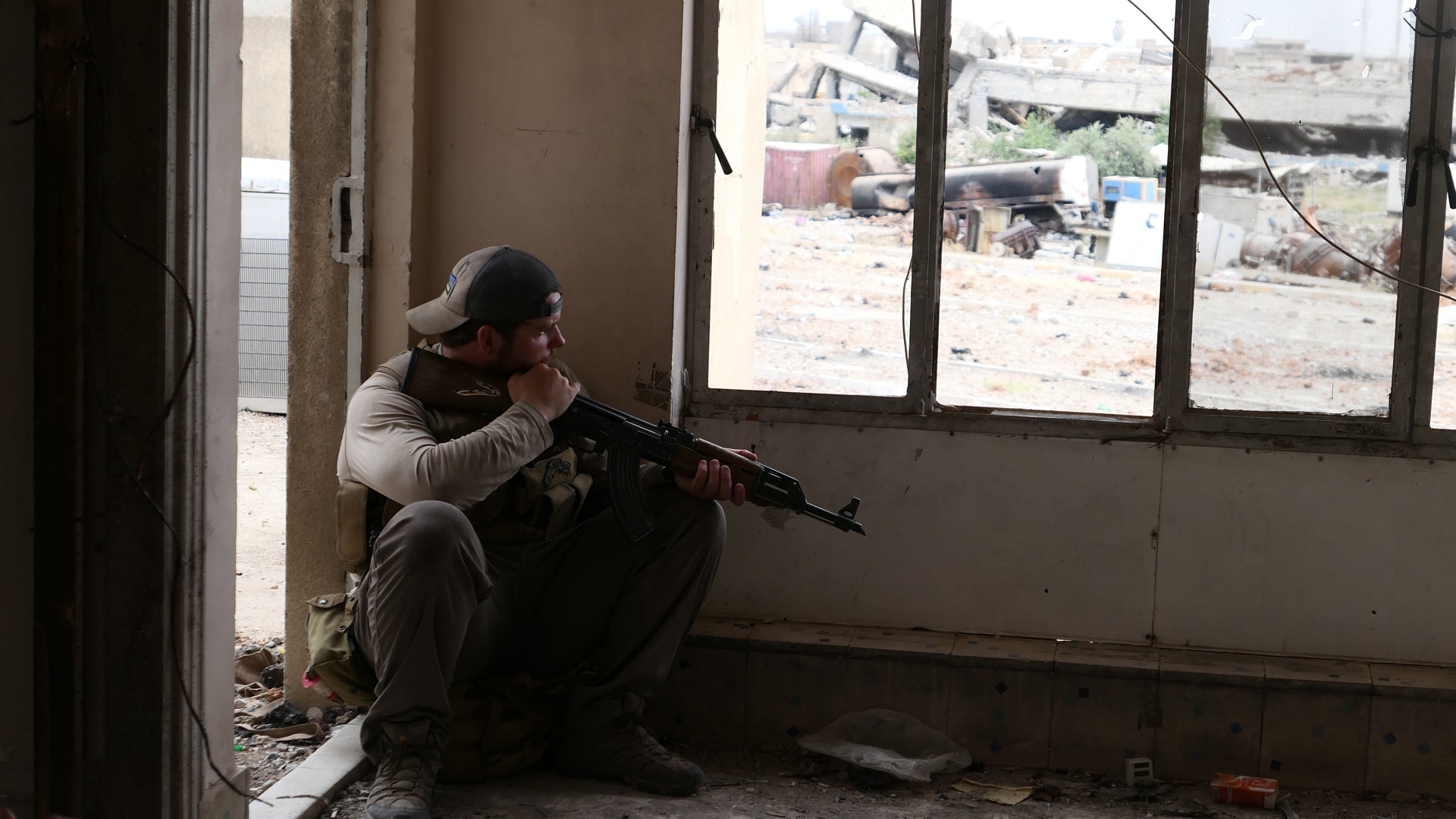 While staying low, Ephraim Mattos surveys the street below littered with dead, June 2, 2017