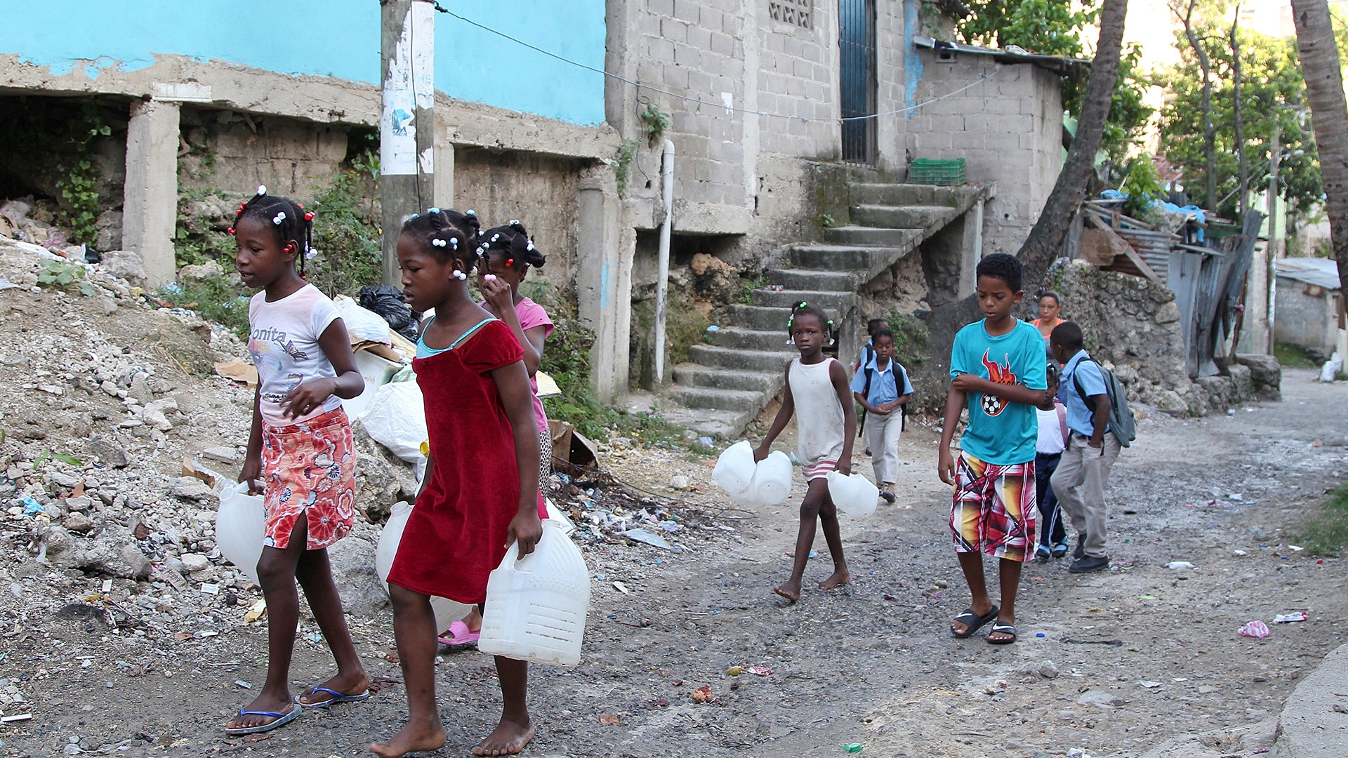 Children carry containers for water as Hurricane Irma approaches on Wednesday, in Santo Domingo, Dominican Republic