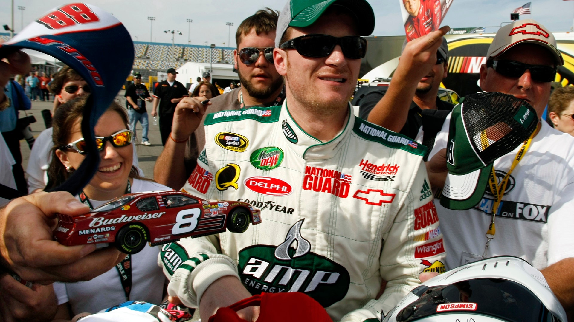 Dale Earnhardt Jr. works his way through a crowd of autograph seekers for the Daytona 500, February 15, 2008