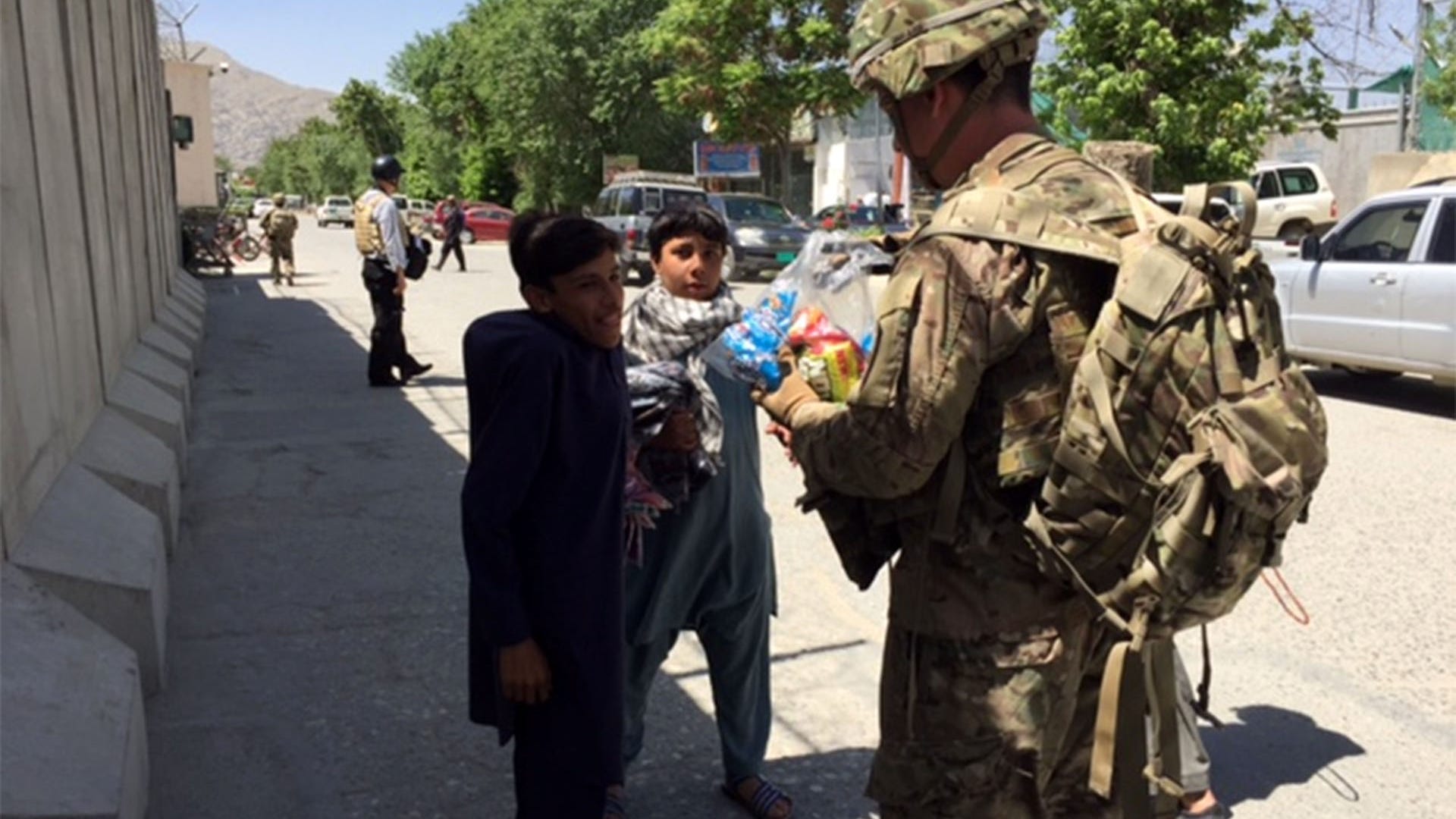 Major Jared Auchey handing out candy
