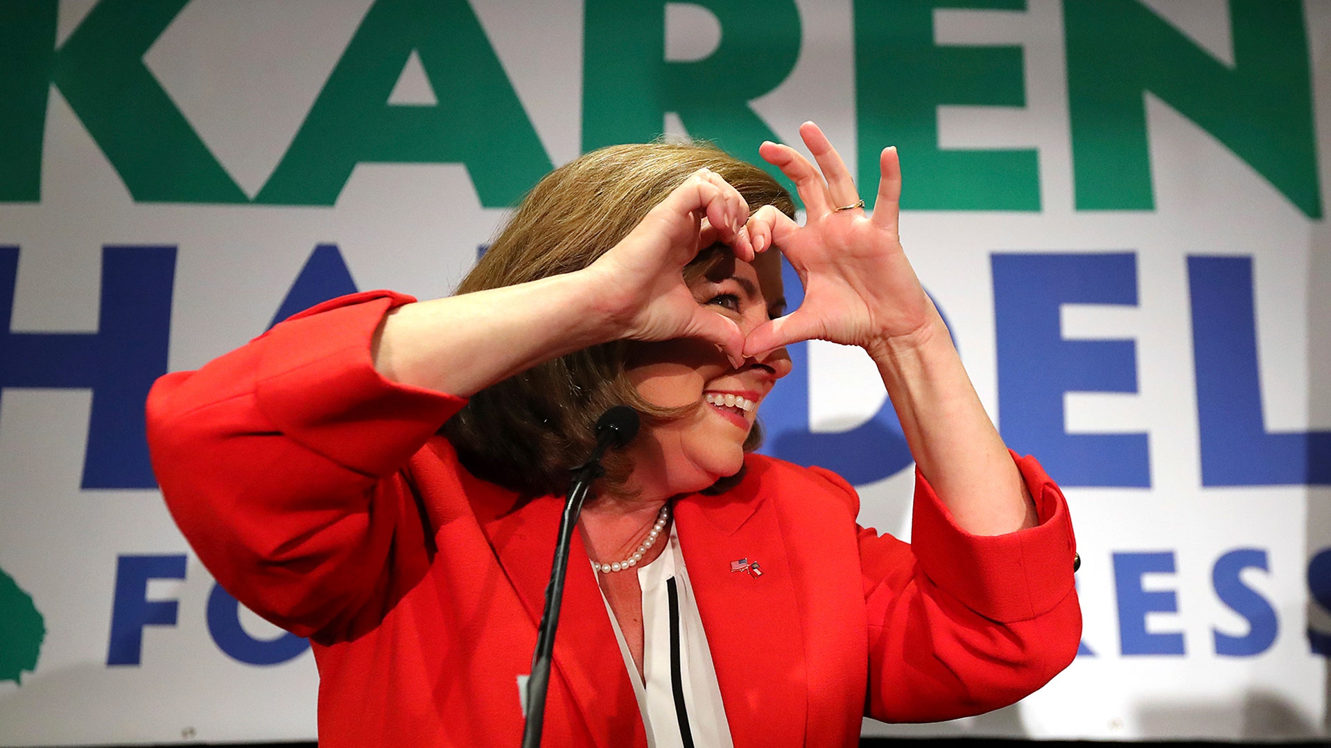 Karen Handel makes a heart symbol to thank her supporters during her election night party on Tuesday, in Atlanta