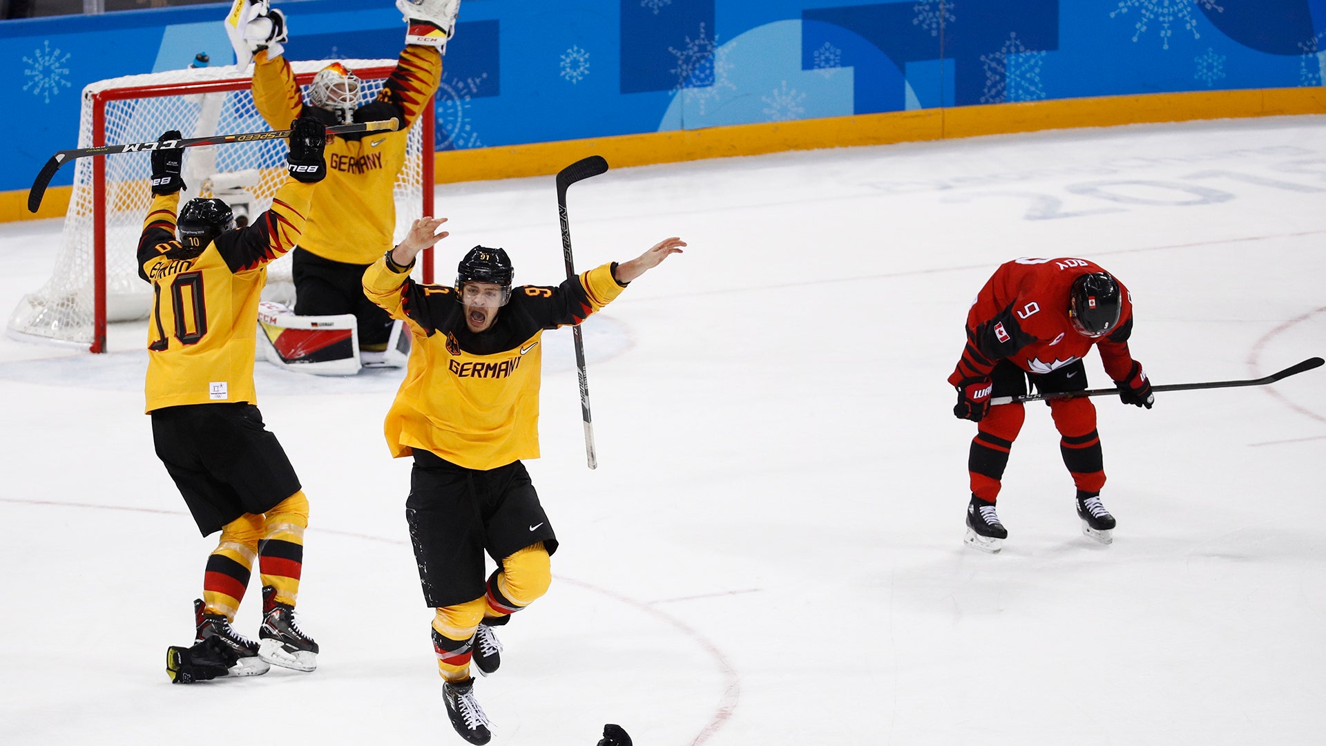 Germany players celebrate defeating Canada in their semi-final match at the 2018 Winter Olympics