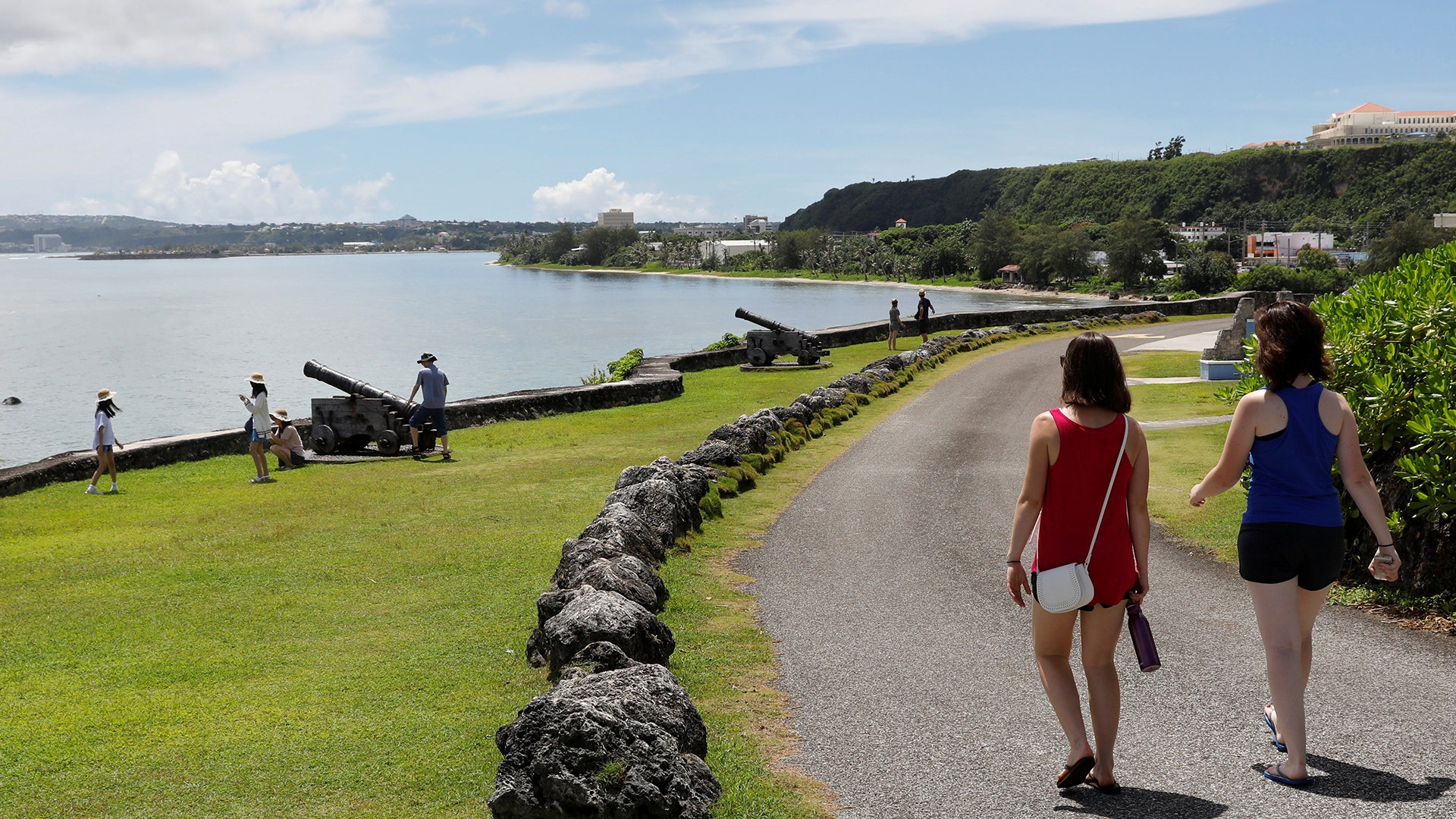Tourists stroll outside a government complex, August 10, 2017.
