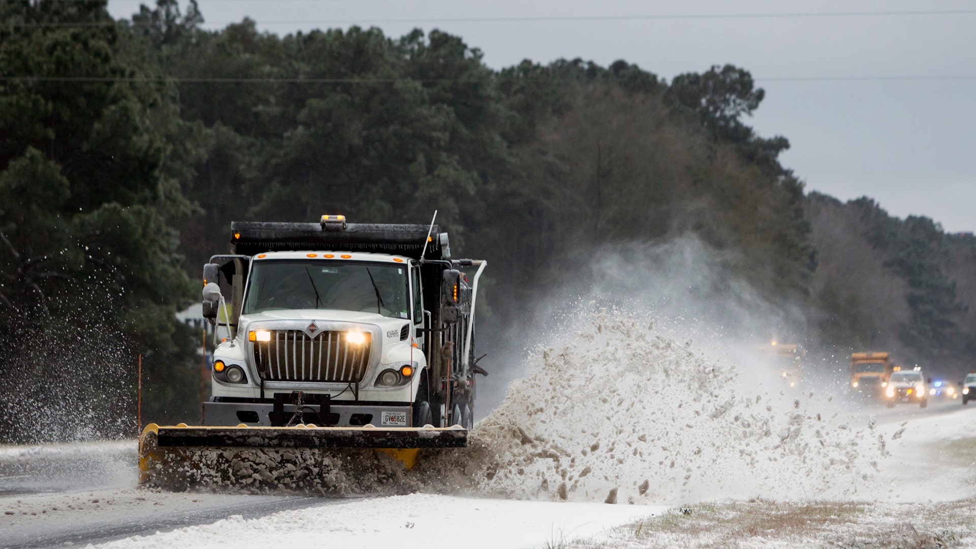 Work crews from Georgia Department of Transportation snow plow a section of Interstate 95, in Savannah, Ga