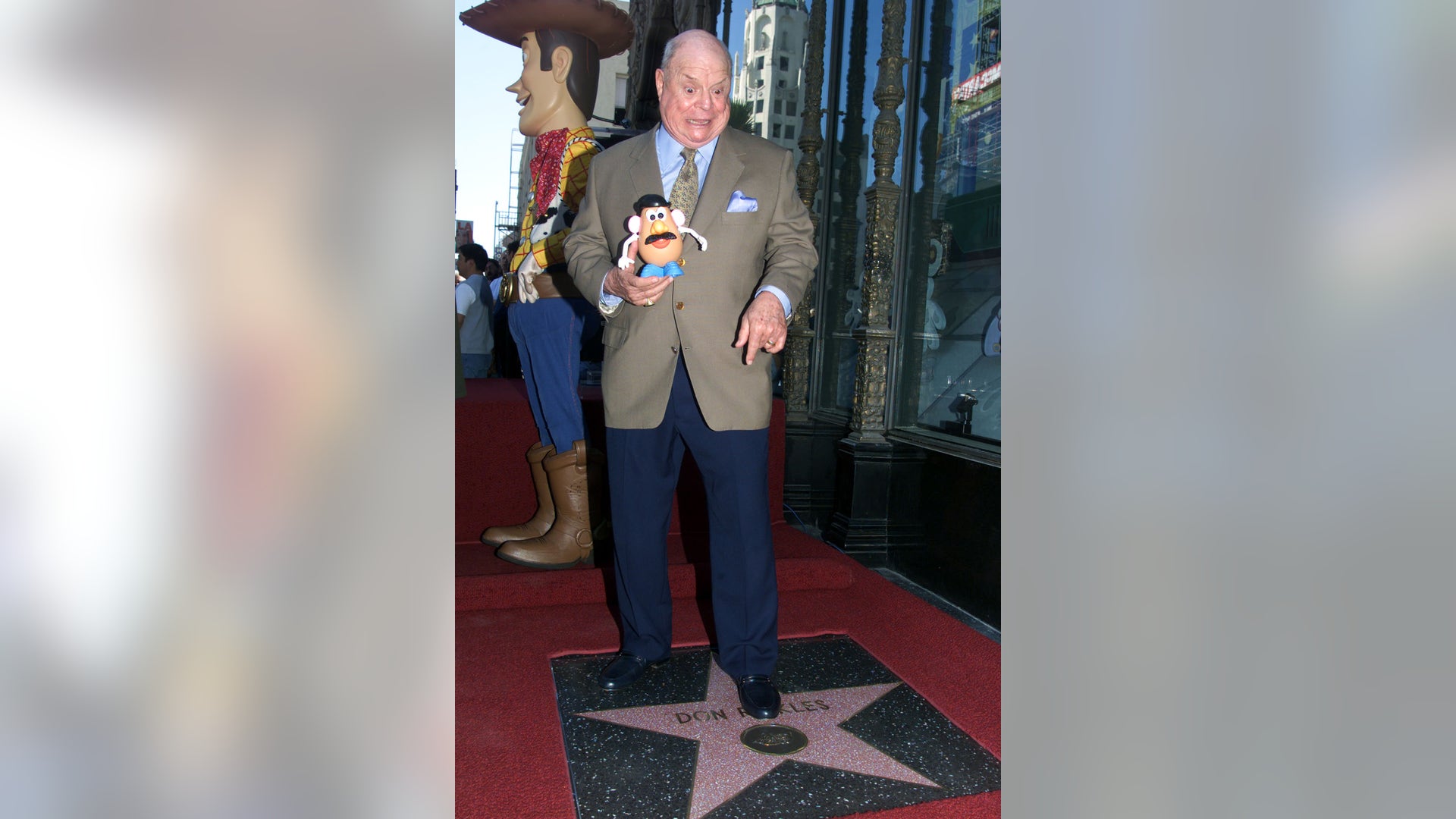 Don Rickles holds a Mr. Potato Head toy as he poses standing on top of his star on the Hollywood Walk of Fame on October 17, 2000