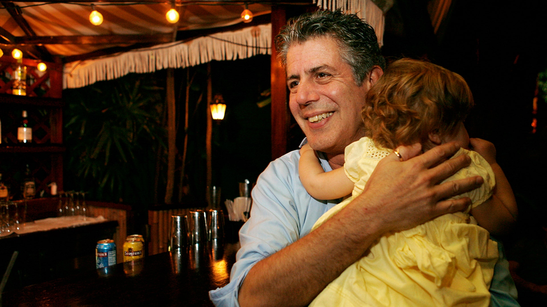 Anthony Bourdain holds his daughter Ariane in Miami Beach, Wednesday, Nov. 12, 2008