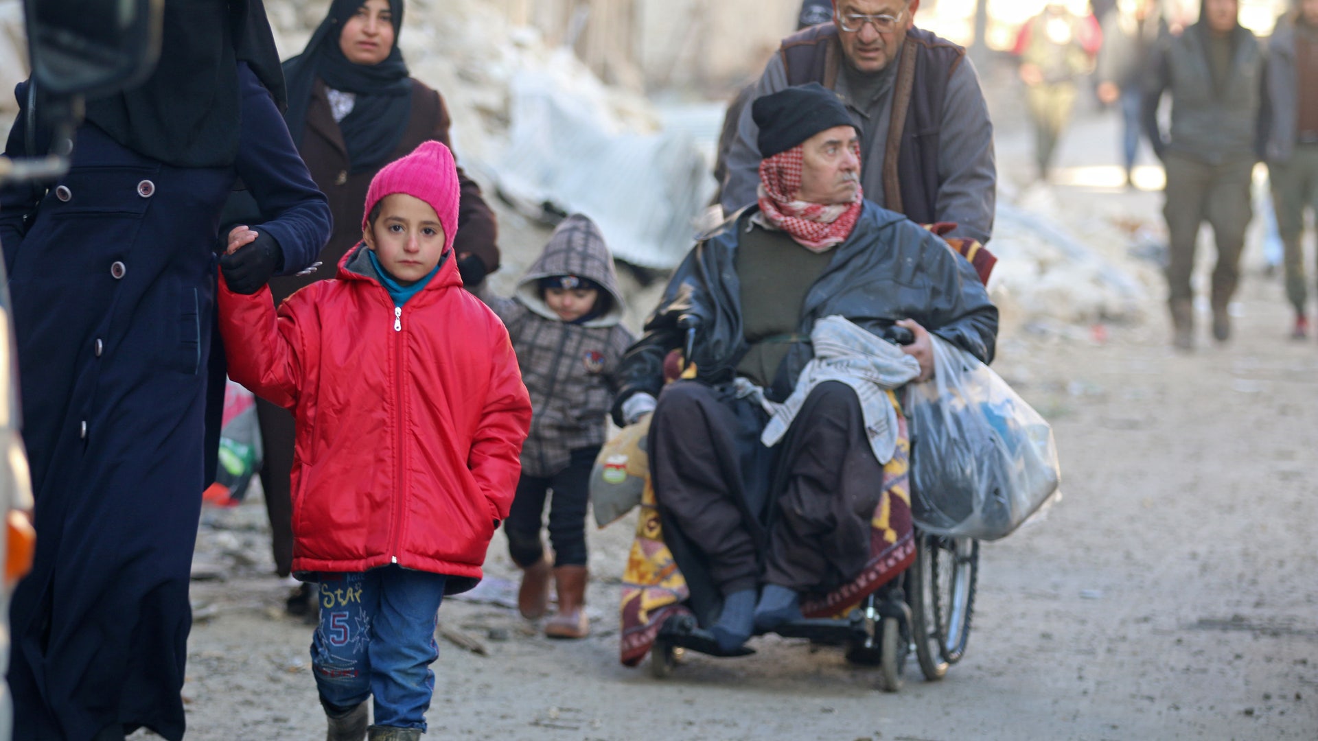 People walk as they gather to be evacuated from a rebel-held sector of eastern Aleppo, Syria December 15, 2016.
