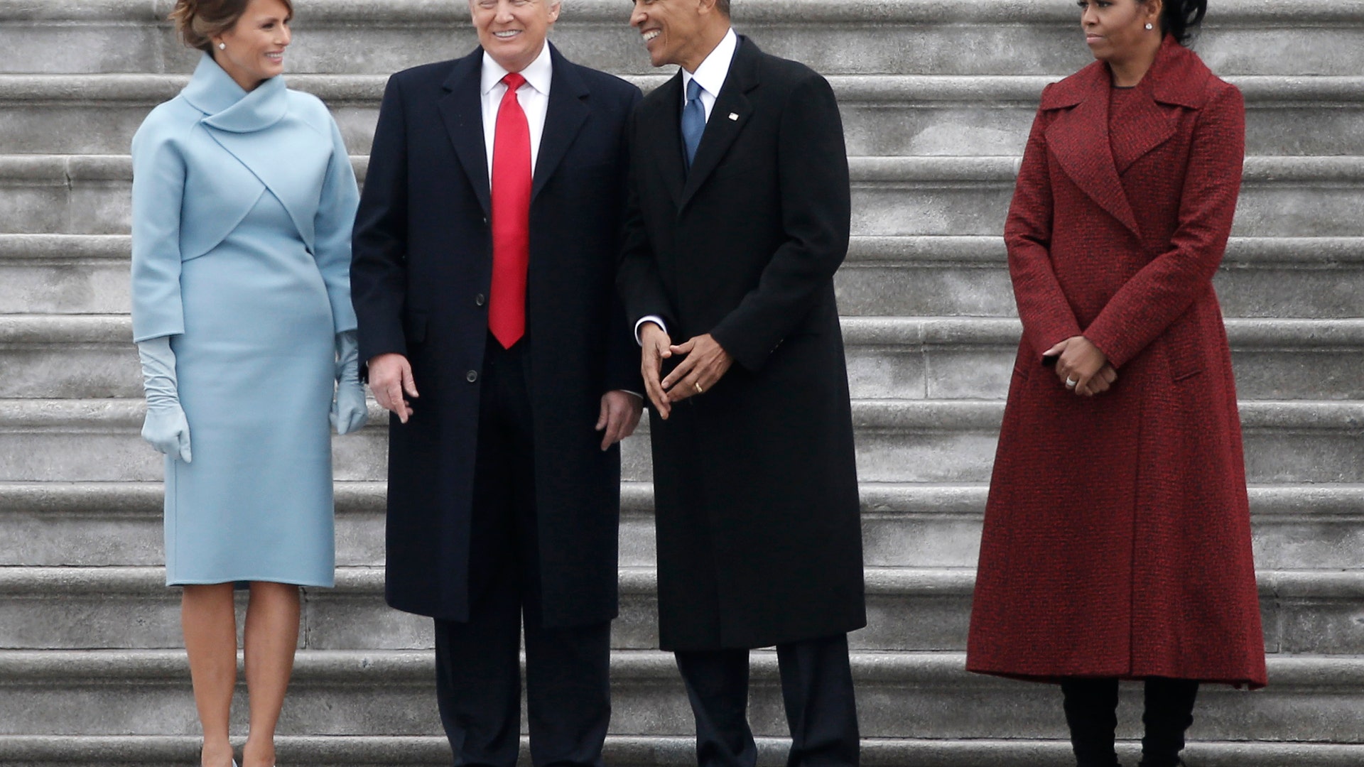 Former president Barack Obama (2nd R) and President Donald Trump share a laugh as former First Lady Michelle Obama (R) and Melania Trump look on following inauguration ceremonies swearing in Trump as the 45th president of the United  States.