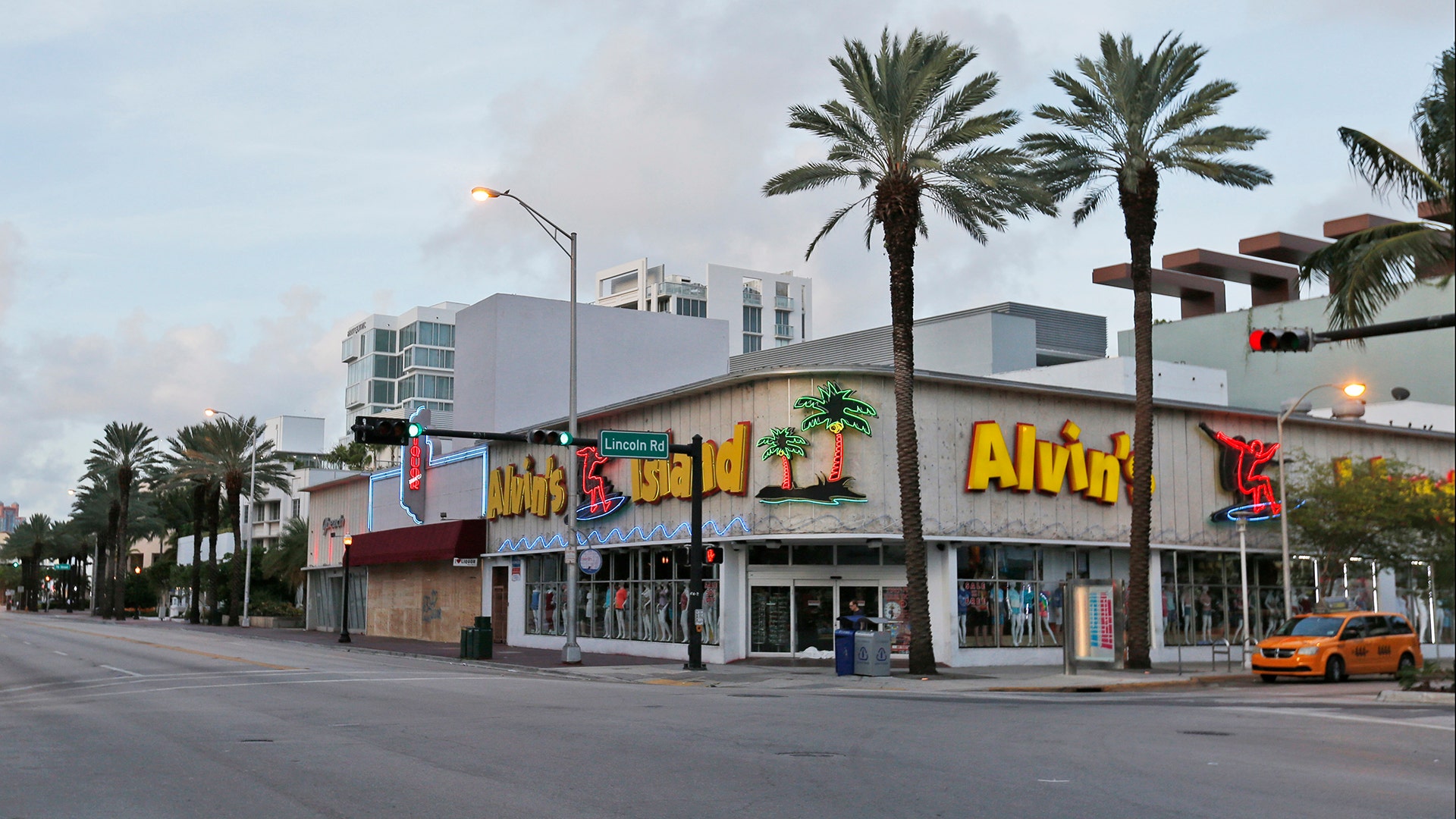 Boarded up buildings on normally bustling South Beach are shown in Miami Beach, Friday