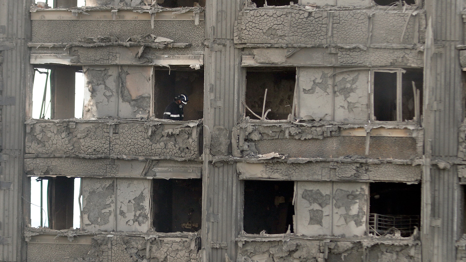 A firefighter inside the destroyed apartment building in London