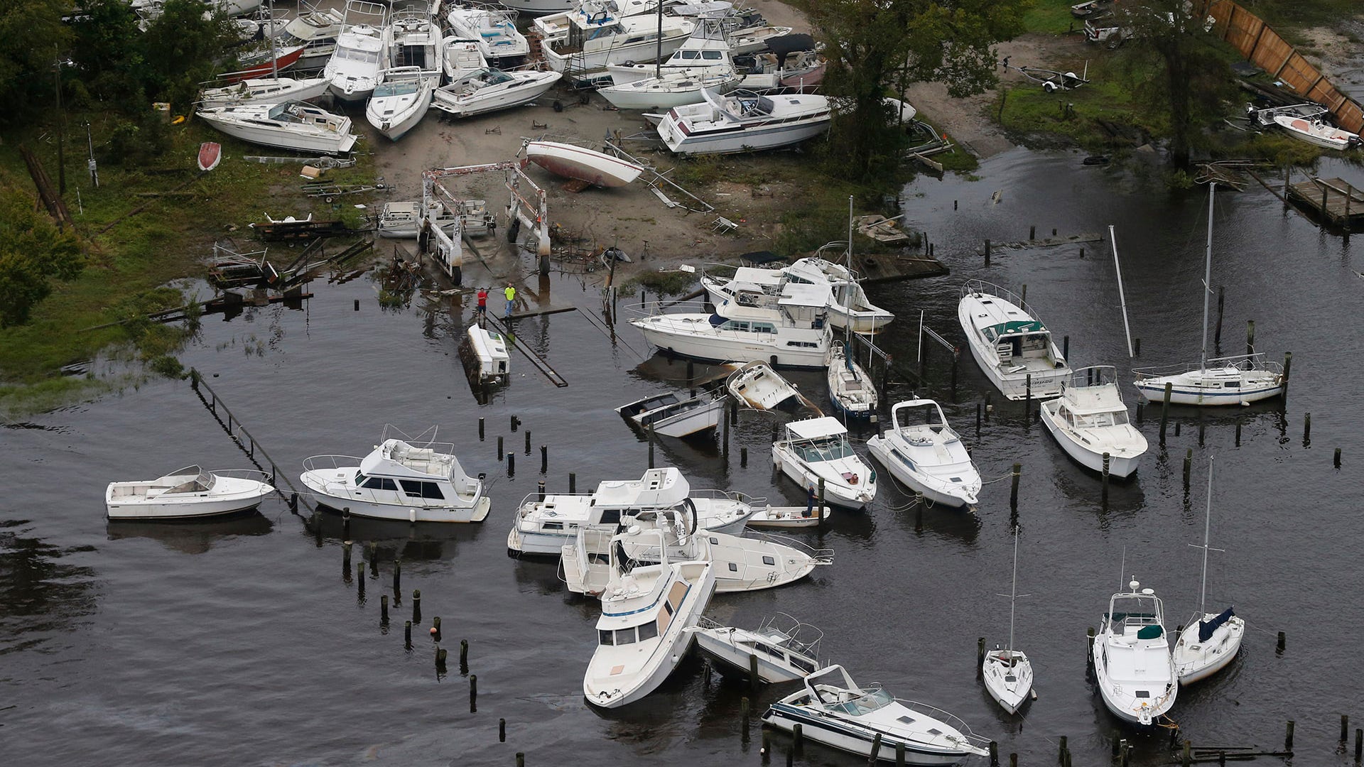 Boats are stacked up on each other in a marina in New Bern, North Carolina, Saturday