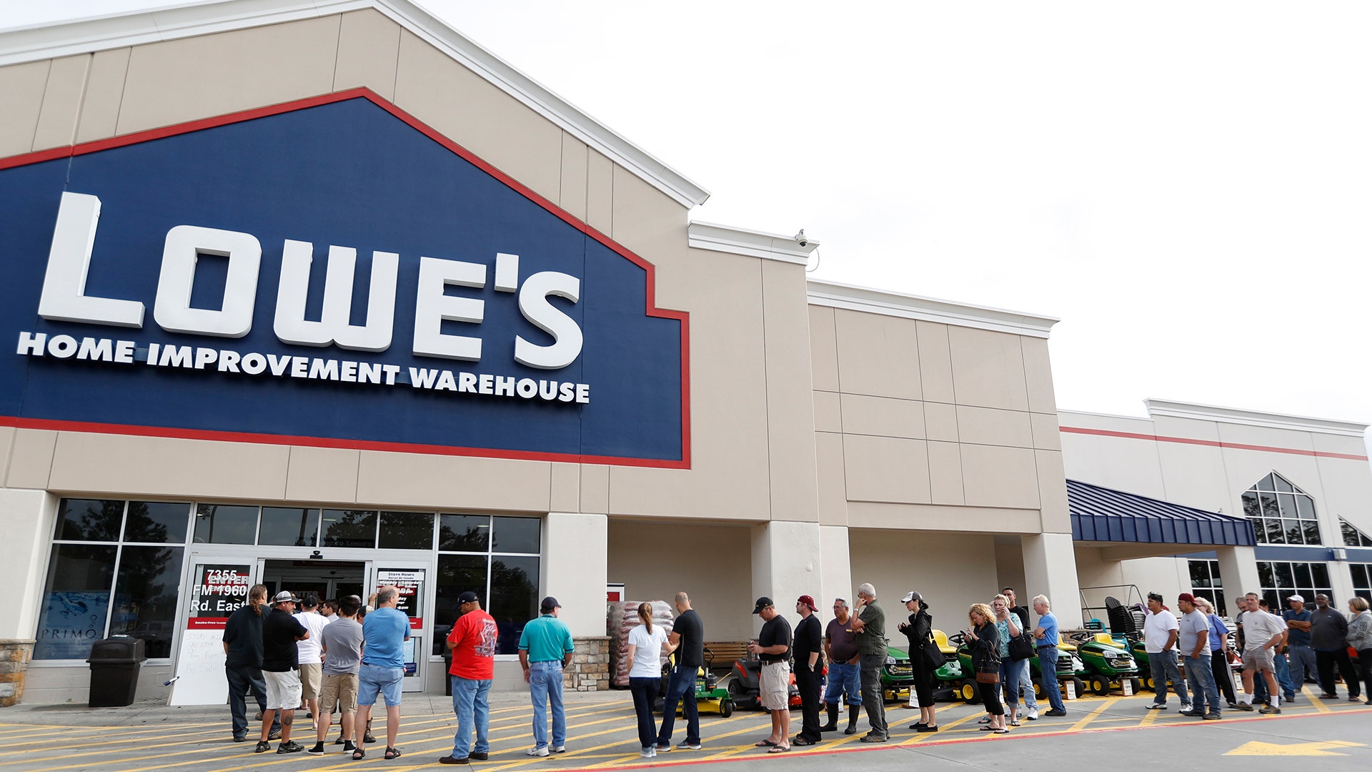 People line up at Lowe's to get supplies after rains and floods from Tropical Storm Harvey started to subside, Wednesday, in Atascocita, Texas