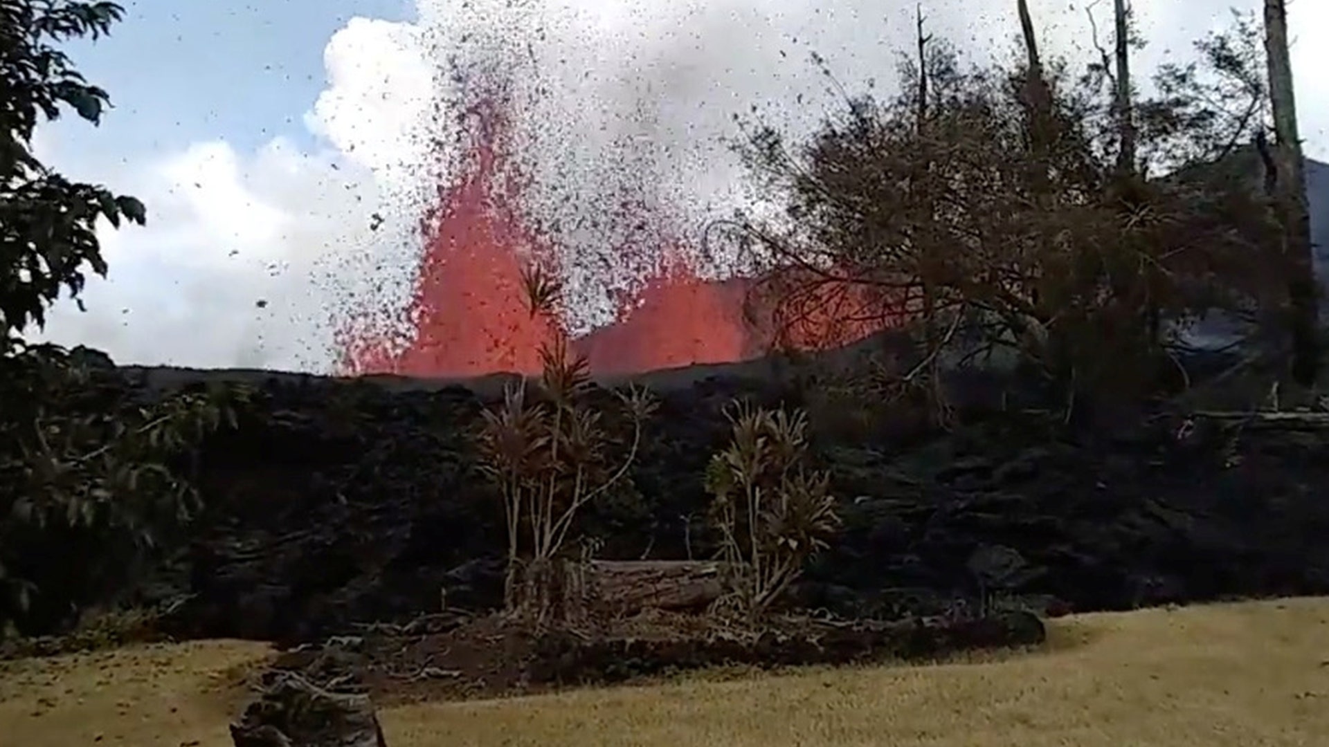 Lava is seen from a fissure appearing behind a resident's backyard in Puna, Hawaii, from May 6, 2018