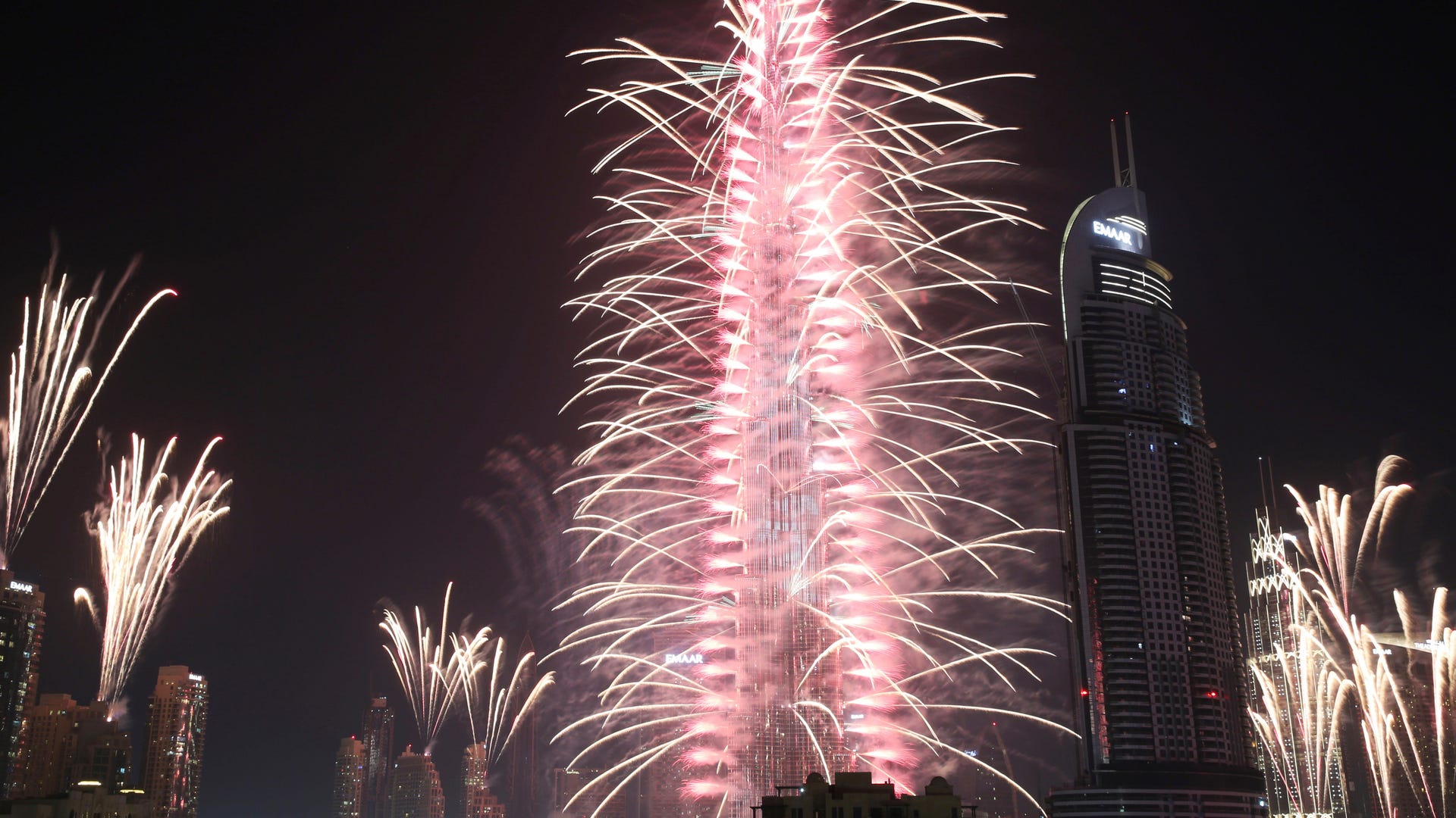 Fireworks explode at the Burj Khalifa, the world's tallest building, and surrounding skyscrapers to mark New Year in Dubai, United Arab Emirates