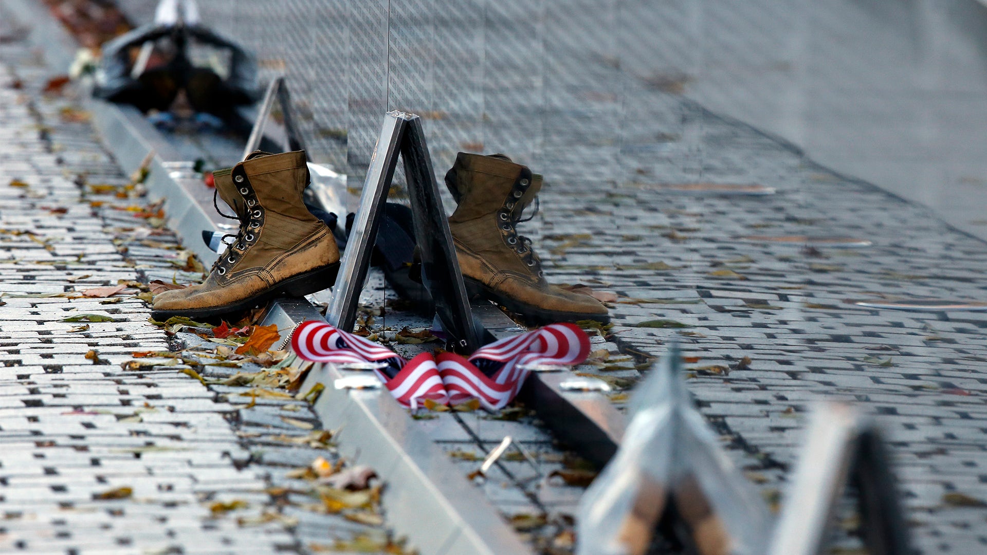 Mementos including a worn pair of boots at the Vietnam Veterans Memorial on Veterans Day