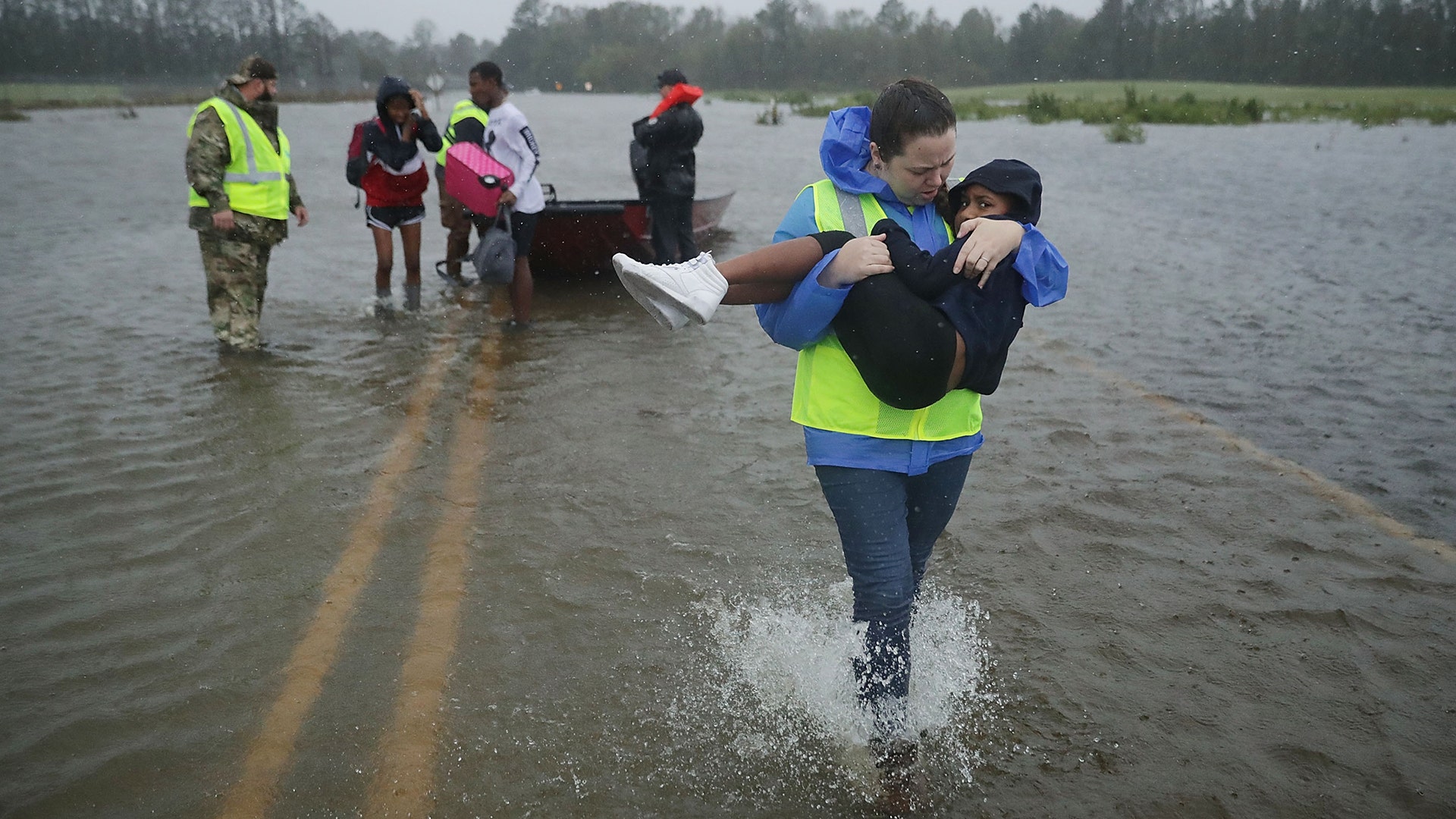 Children are rescued from their flooded home during Hurricane Florence in James City, North Carolina, Friday