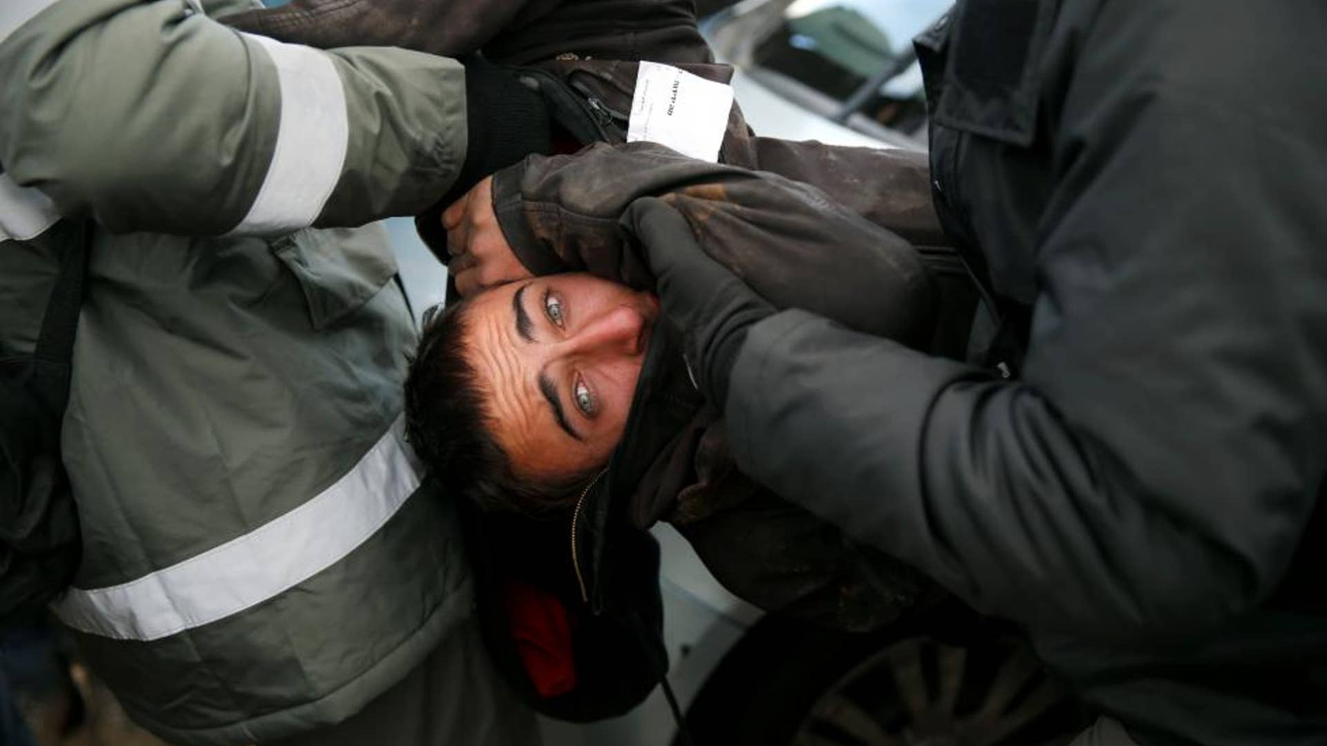 Israeli policemen remove a pro-settlement activist during an operation by Israeli forces to evict settlers from the outpost of Amona in the occupied West Bank.