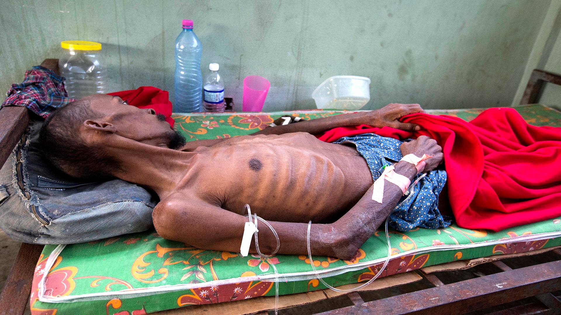 A prisoner, too weak to stand, lies in the prison infirmary at the National Penitentiary in downtown Port-au-Prince, Haiti