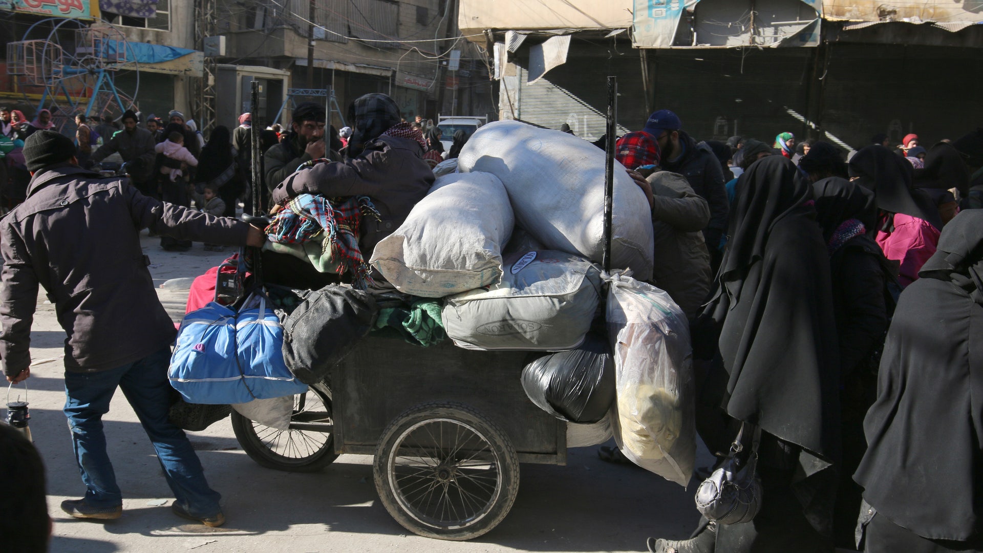 People walk as they gather to be evacuated from a rebel-held sector of eastern Aleppo, Syria December 15, 2016.