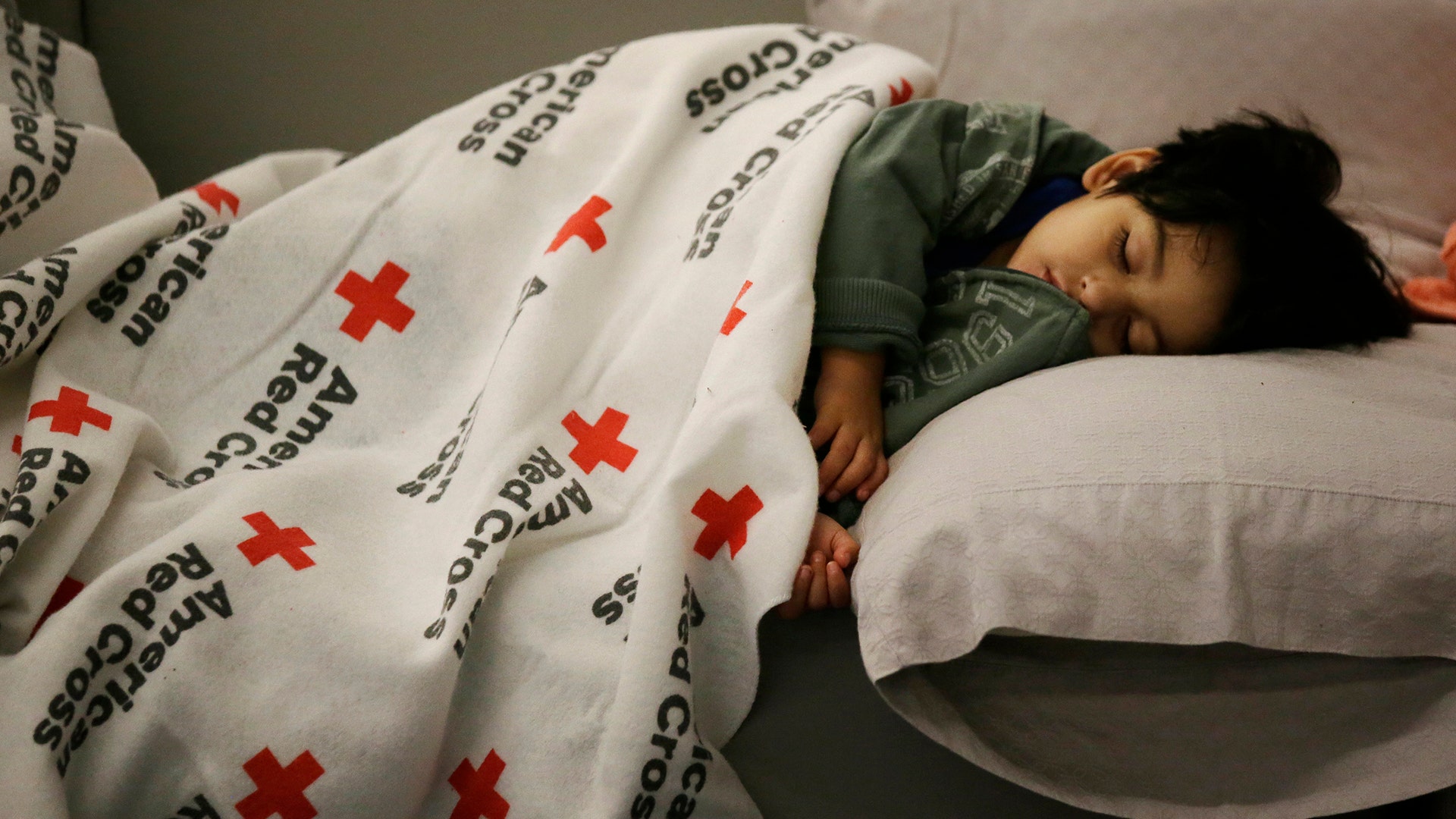 Malachia Medrano, 2, sleeps at the George R. Brown Convention Center being used as a shelter for evacuees in Houston, Texas, Tuesday