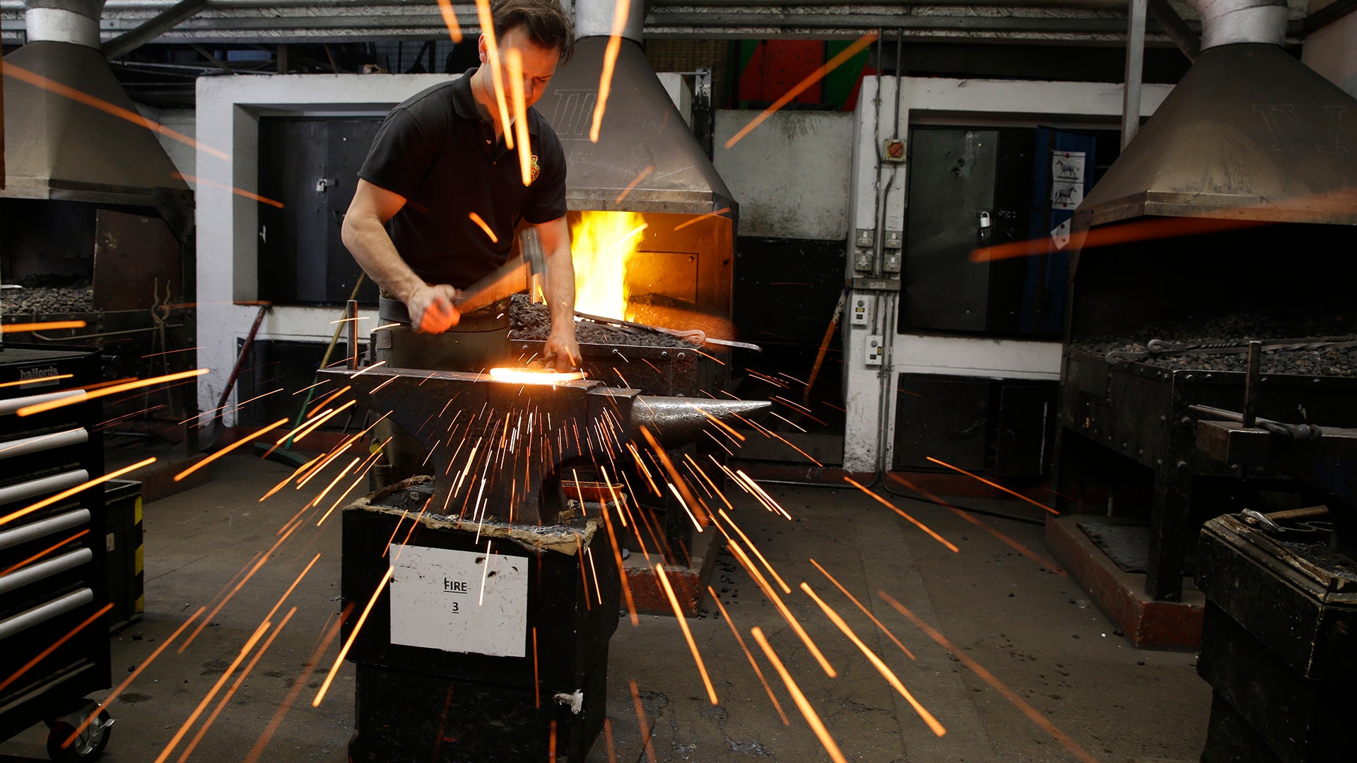 A Household Cavalry farrier fashions a horse shoe in the blacksmith shop at the unit's barracks in London, May 9, 2018