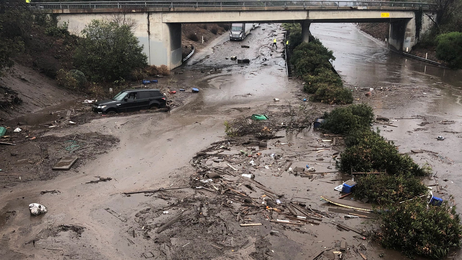 Abadoned cars stuck in flooded water on the freeway after a mudslide in Montecito, California, January 9, 2018