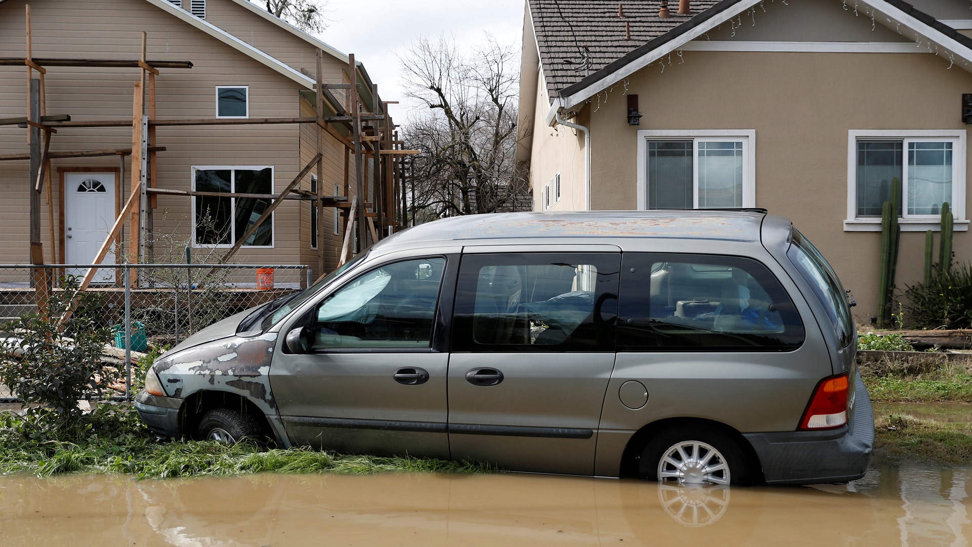 A car is seen partially submerged in water after Coyote Creek burst its banks and flooded nearby neighborhoods in San Jose, California. 