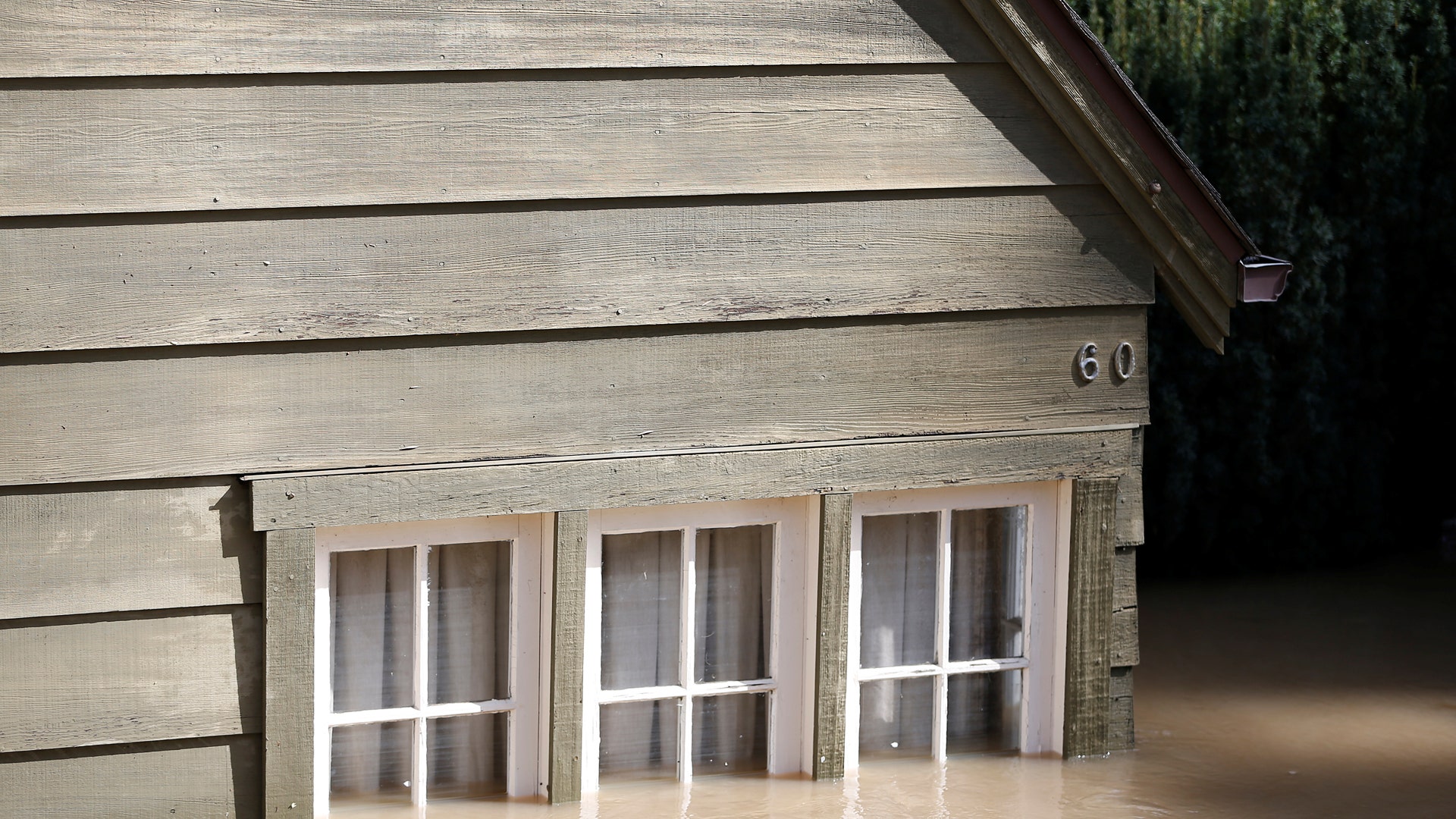 A home is seen submerged in water after an overflowed Coyote Creek flooded nearby neighborhoods in San Jose, California. 