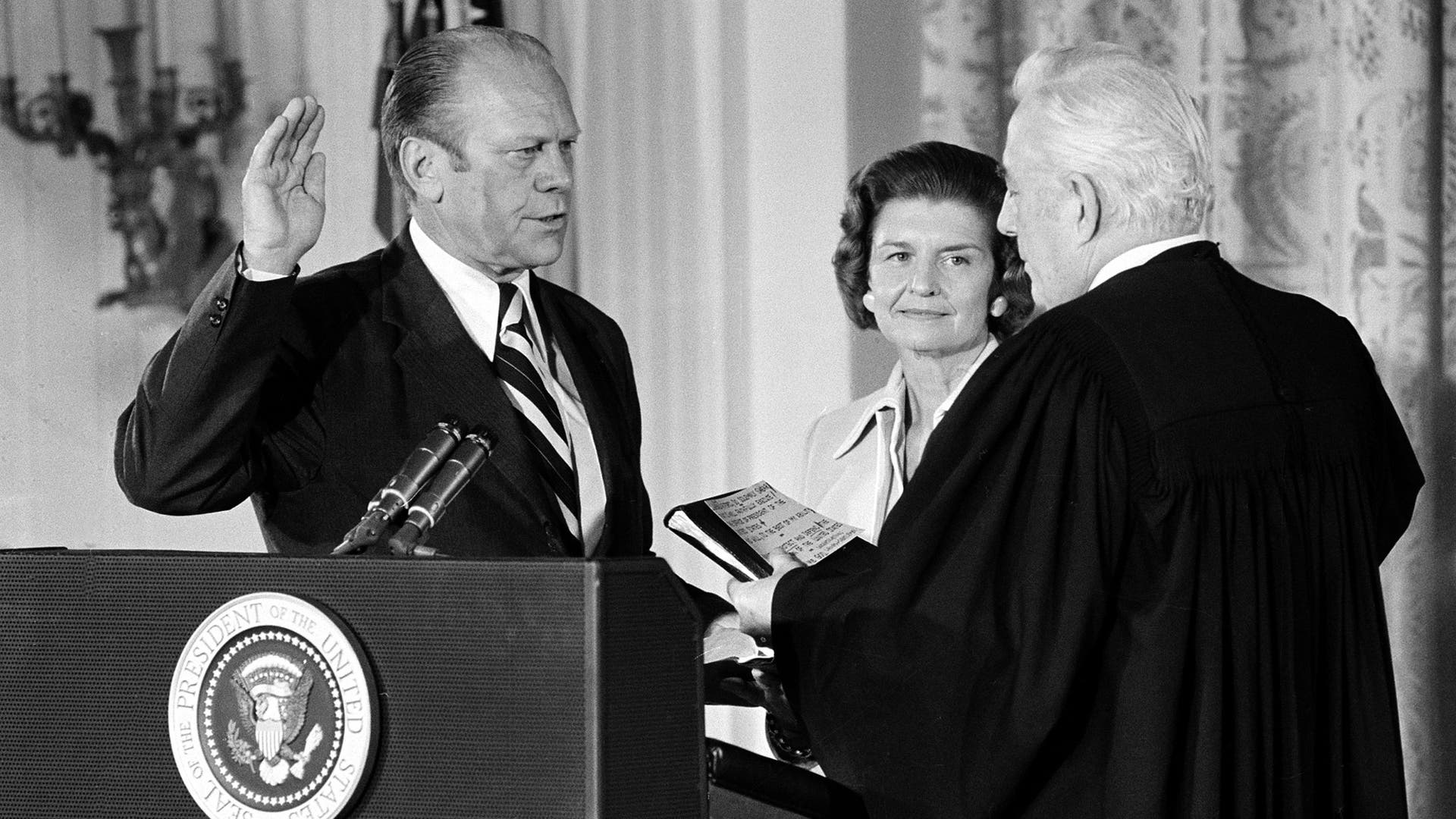 U.S. Chief Justice Warren Burger administers the oath of office to Gerald Ford in the East Room of the White House in Washington, D.C., Aug. 9, 1974.