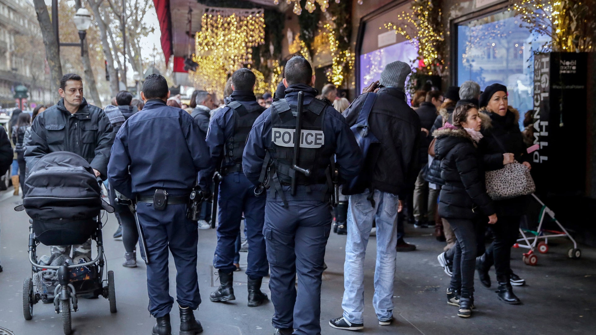 French cops patrol outside the Galeries Lafayette department store in Paris, on Tuesday, a day after a truck ran into a crowded Christmas market in Berlin.