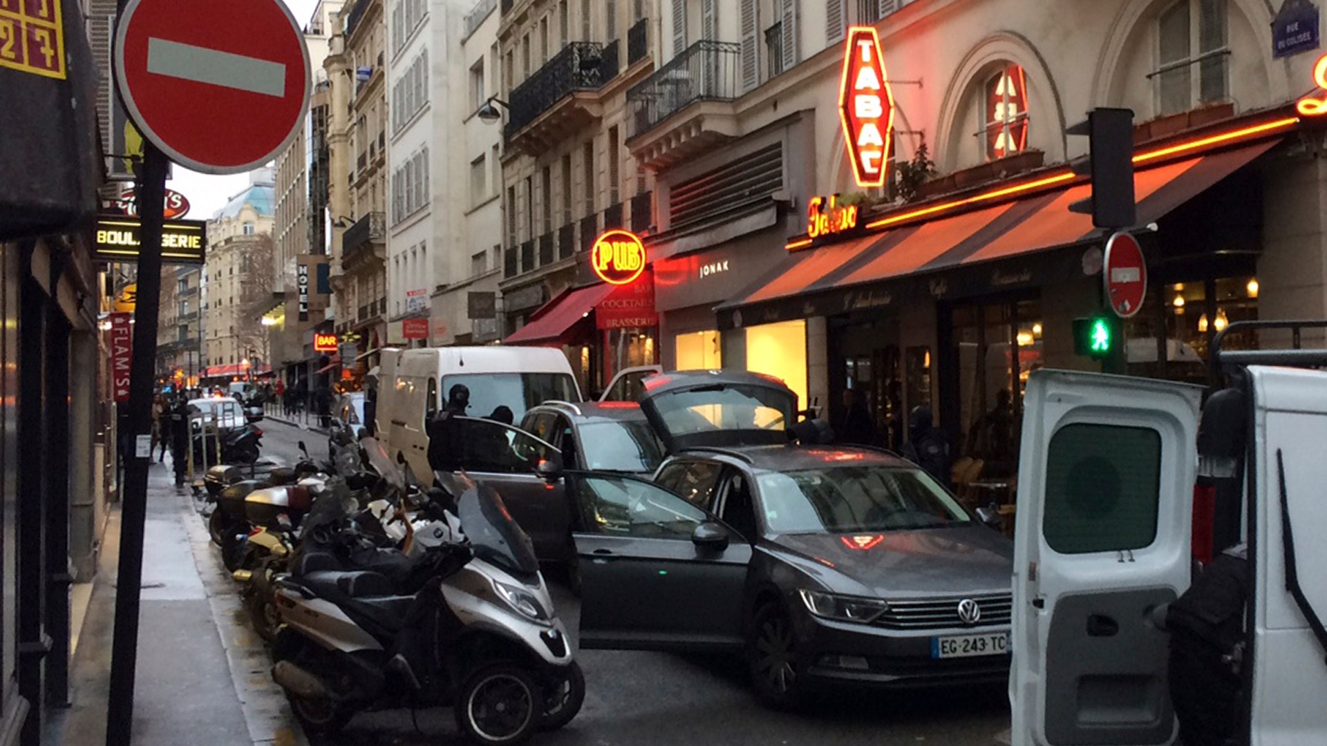 Hooded police officers search a building in connection with a shooting outside at the museum in Paris, Friday Feb. 3, 2017.
